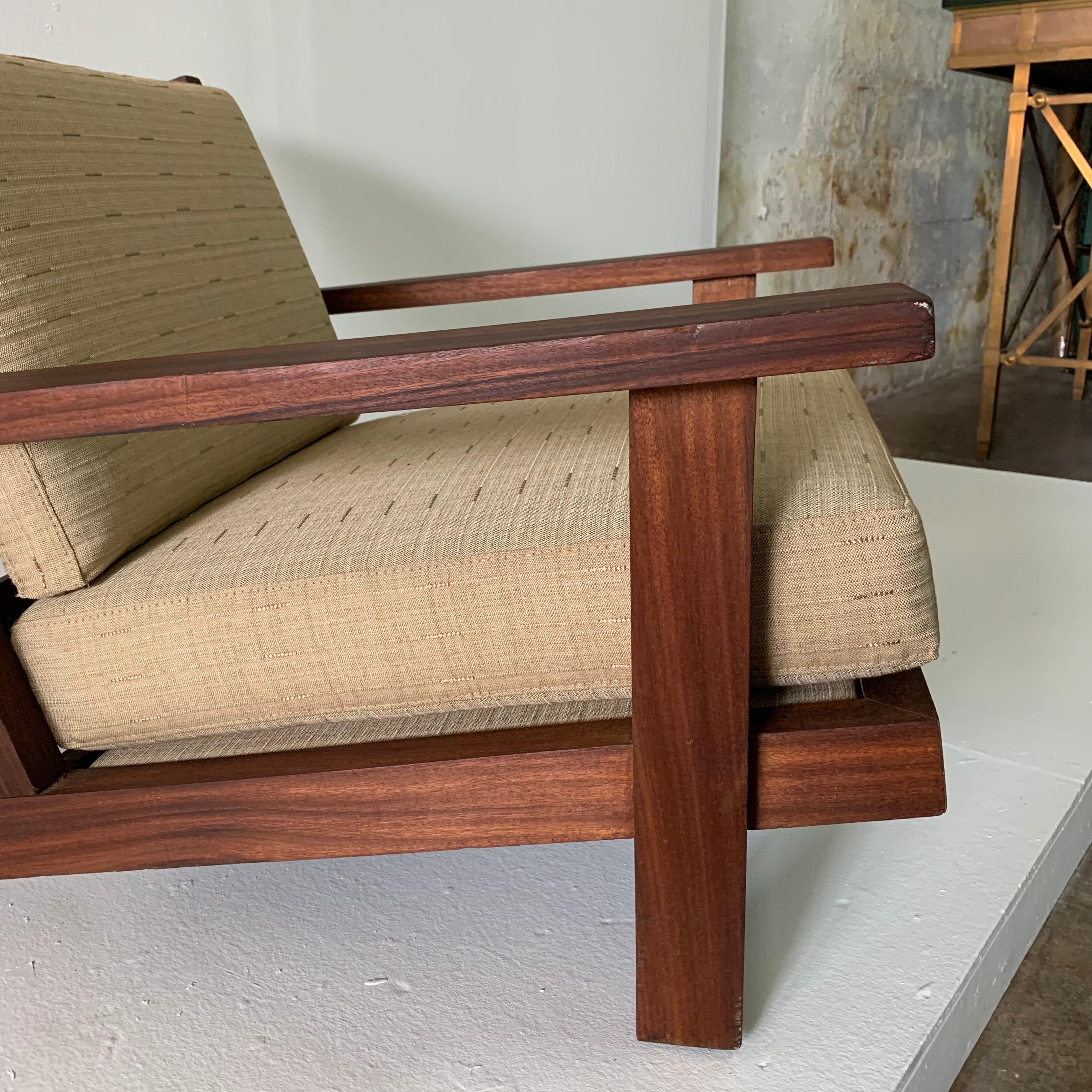 This is a wide, deep and low all teak armchair from France, made in 1960s. Finished with a beach-vibe fabric in neutral tones. This was acquired from the Estate of Amy Perlin, New York. There is a second similar style chair with a higher back