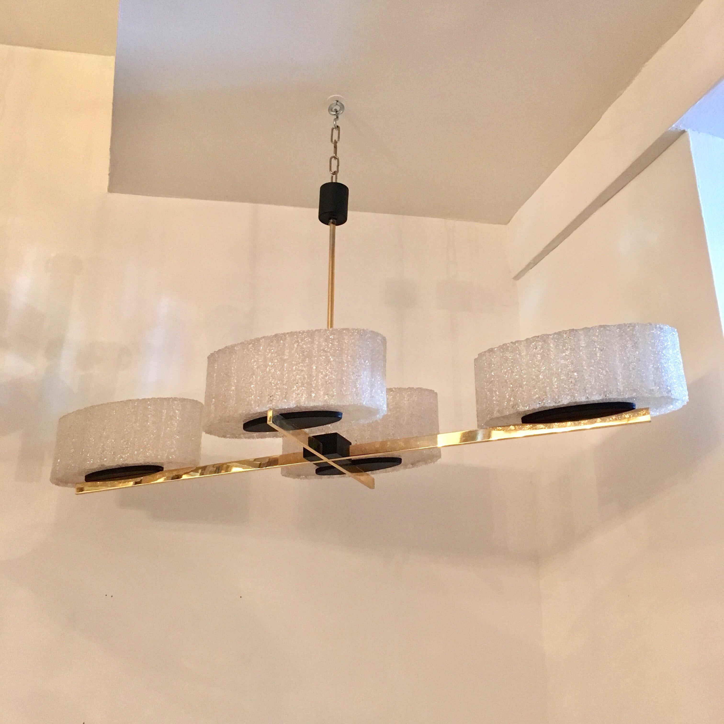A sleek 1960s French chandelier composed of a polished brass and black enamel body and four large spun resin shades. Newly wired.