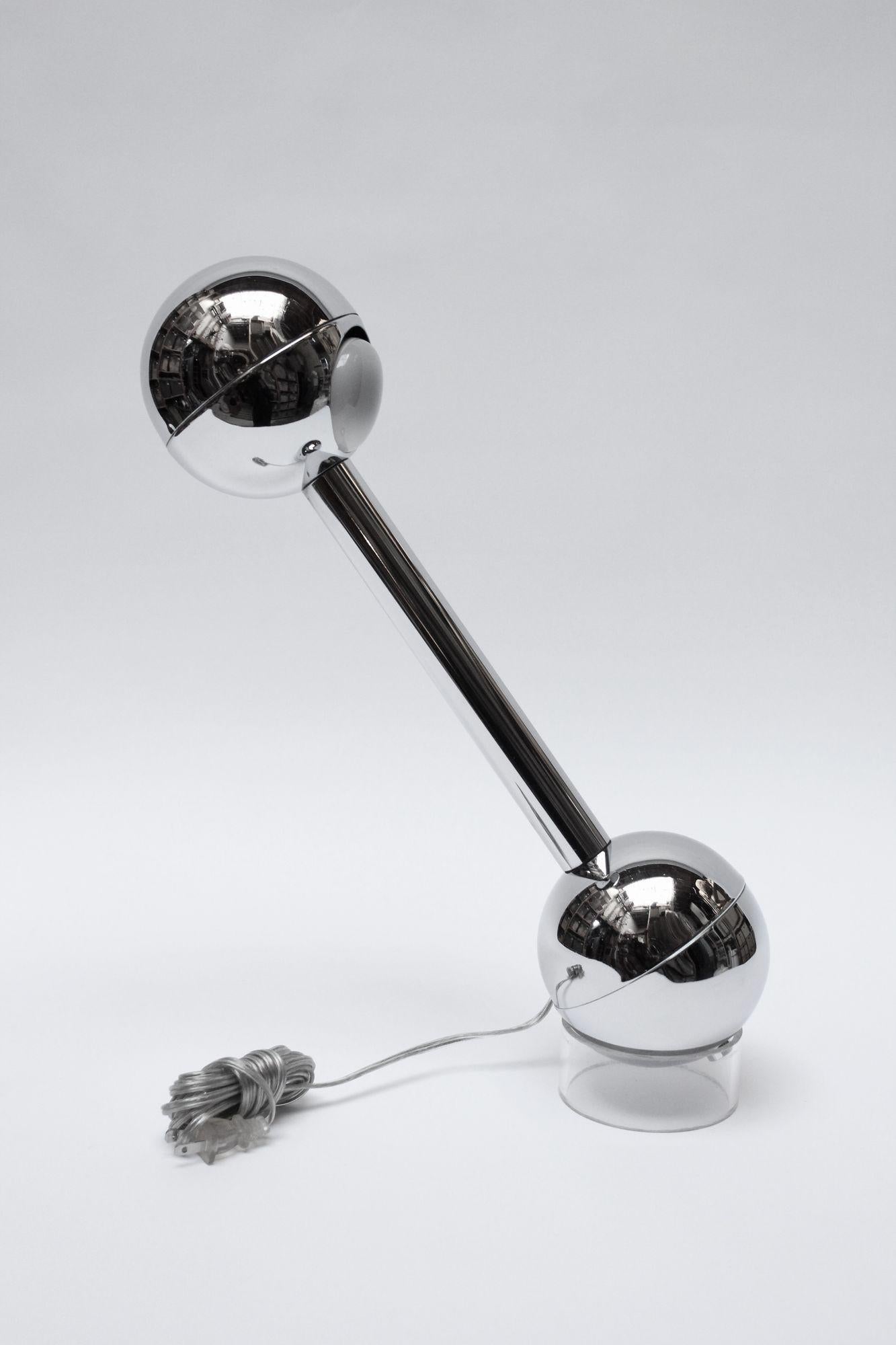 Pierre Cardin 'barbell' pivoting chrome table lamp (ca. 1960s, France). Similar to a version by John Mascheroni for Kovacs lamp with slight design and material disparities. 
The on/off operation is controlled internally by a mercury switch, which