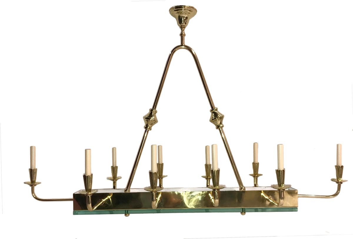 A circa 1960's French gilt bronze ten-arm horizontal chandelier with glass inset.

Measurements:
Height/Drop: 58