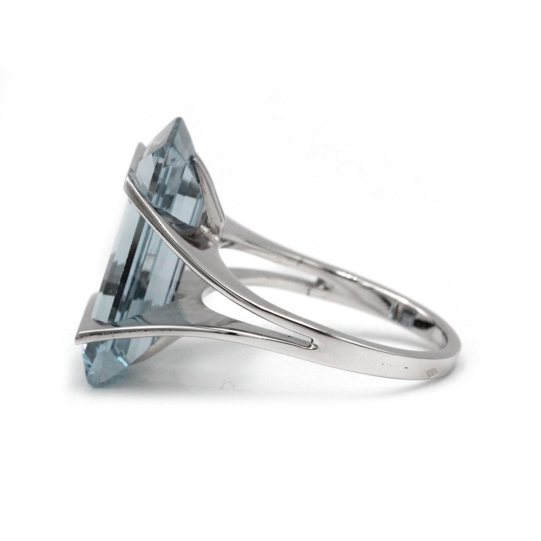 Crafted in France during the 1970s, this striking statement ring showcases a superb emerald-cut aquamarine of icy-blue transparency, set in a streamlined 18K white gold mounting. Its clean-lined, open-gallery design and gently split shoulders