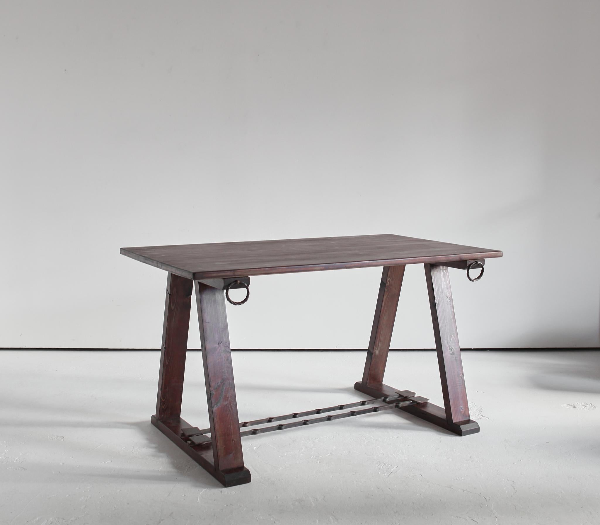 A C.1960s modernist alpine table from the Savoie region of France.

Simple trestle  construction with decorative artisanal ironwork stretcher and hardware.