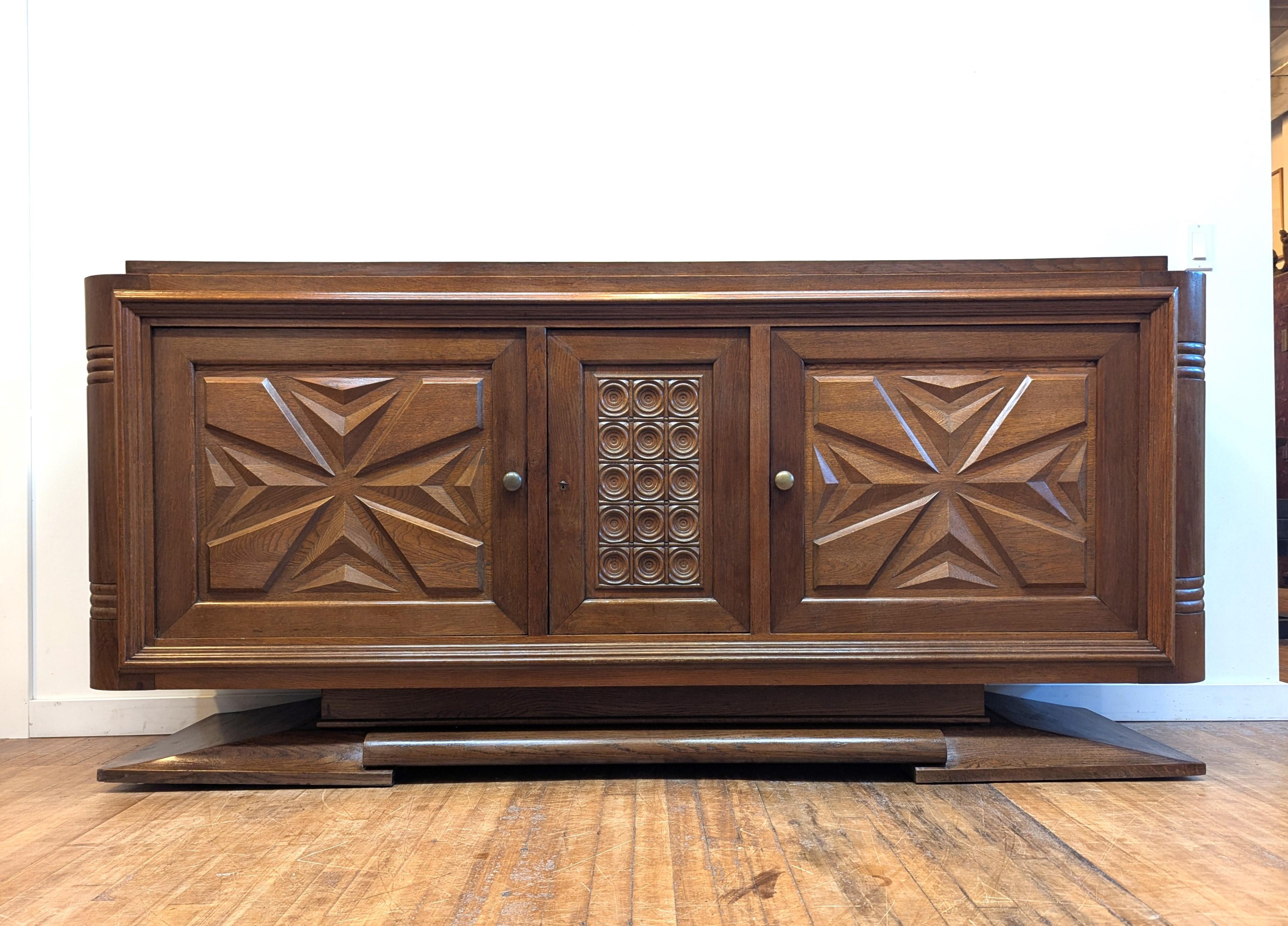 French Modernist Credenza Sideboard late Art Deco attributed to Gaston Poisson.  Sensational French sideboard made in Paris 1940's showcasing an Art Deco Modernist design.   Beautifully incorporated geometric triangular shapes sculpted into the door