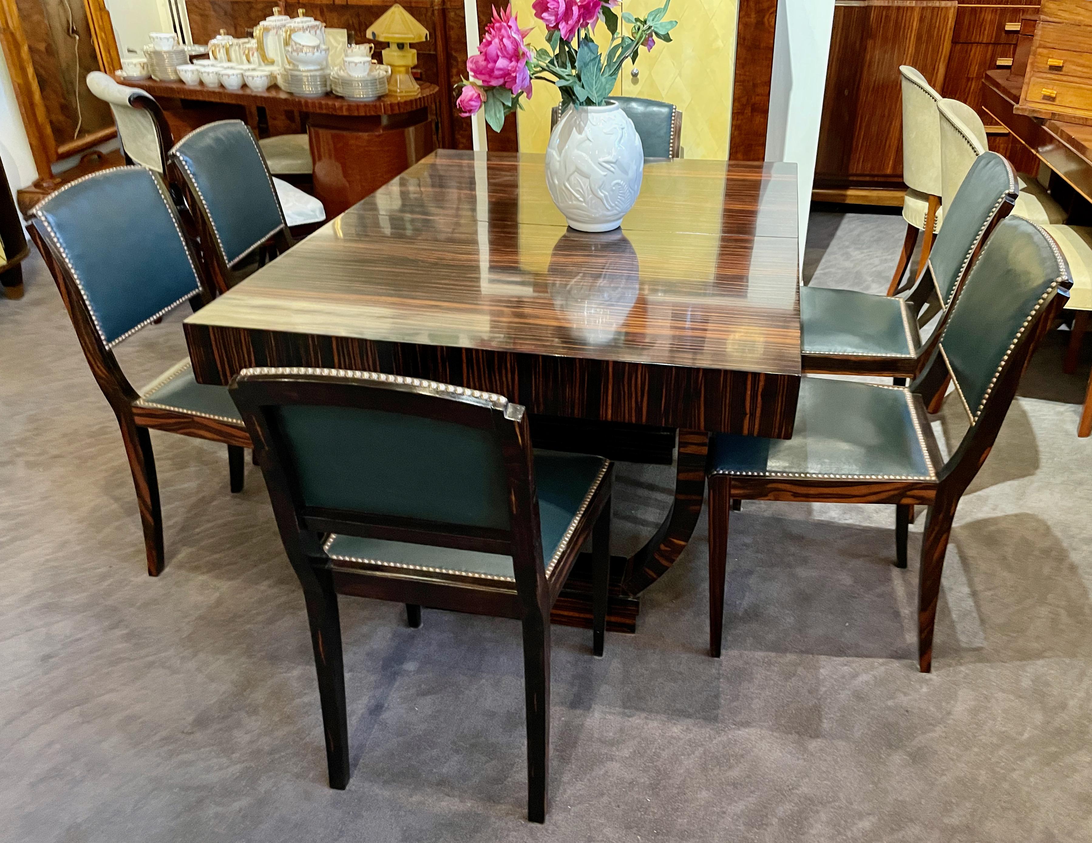 Expandable French modernist Art Deco Macassar wood table with 6 matching chairs. Intense Macassar grain wood with matching deep side wood skirt (4.5?). Double tier leg support system with quality expandable center extension. Fits perfect, it’s all