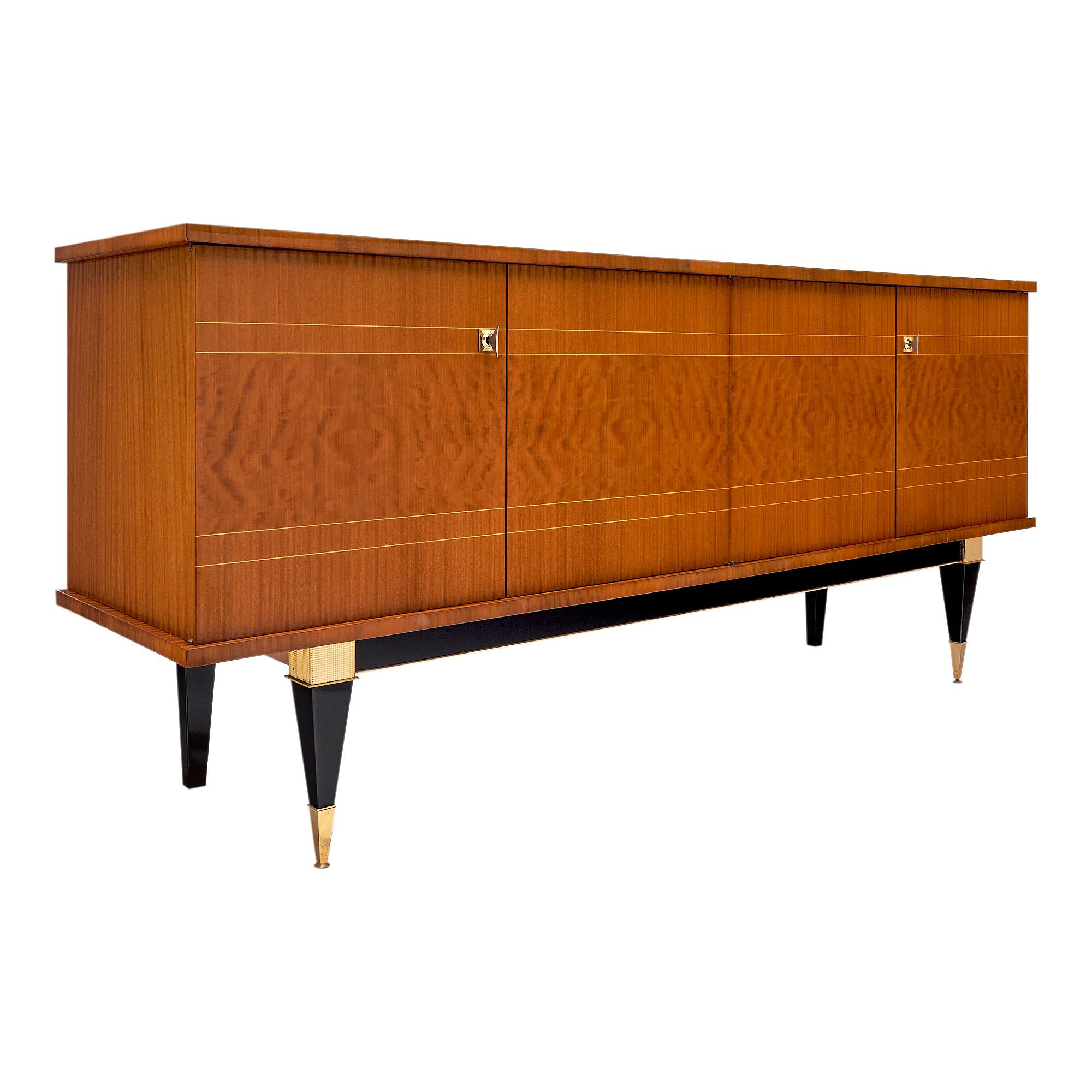 French buffet/enfilade from the Modernist era, the classical credenza features a combination of various types of blond Mahogany including “acajou mouchete”, striped mahogany, and lemon wood inlays. Four strong tapered legs support the four doors