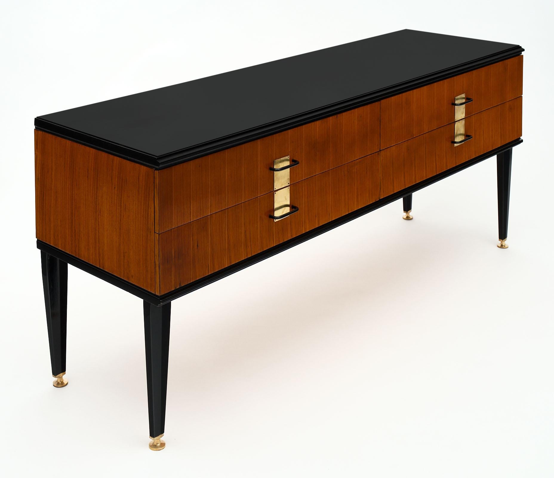 French modernist chest in the manner of Jacques Adnet. Made of rosewood and ebonized rosewood; this piece features brass hardware and beautiful tapered legs with bronze feet. It is in excellent vintage condition!