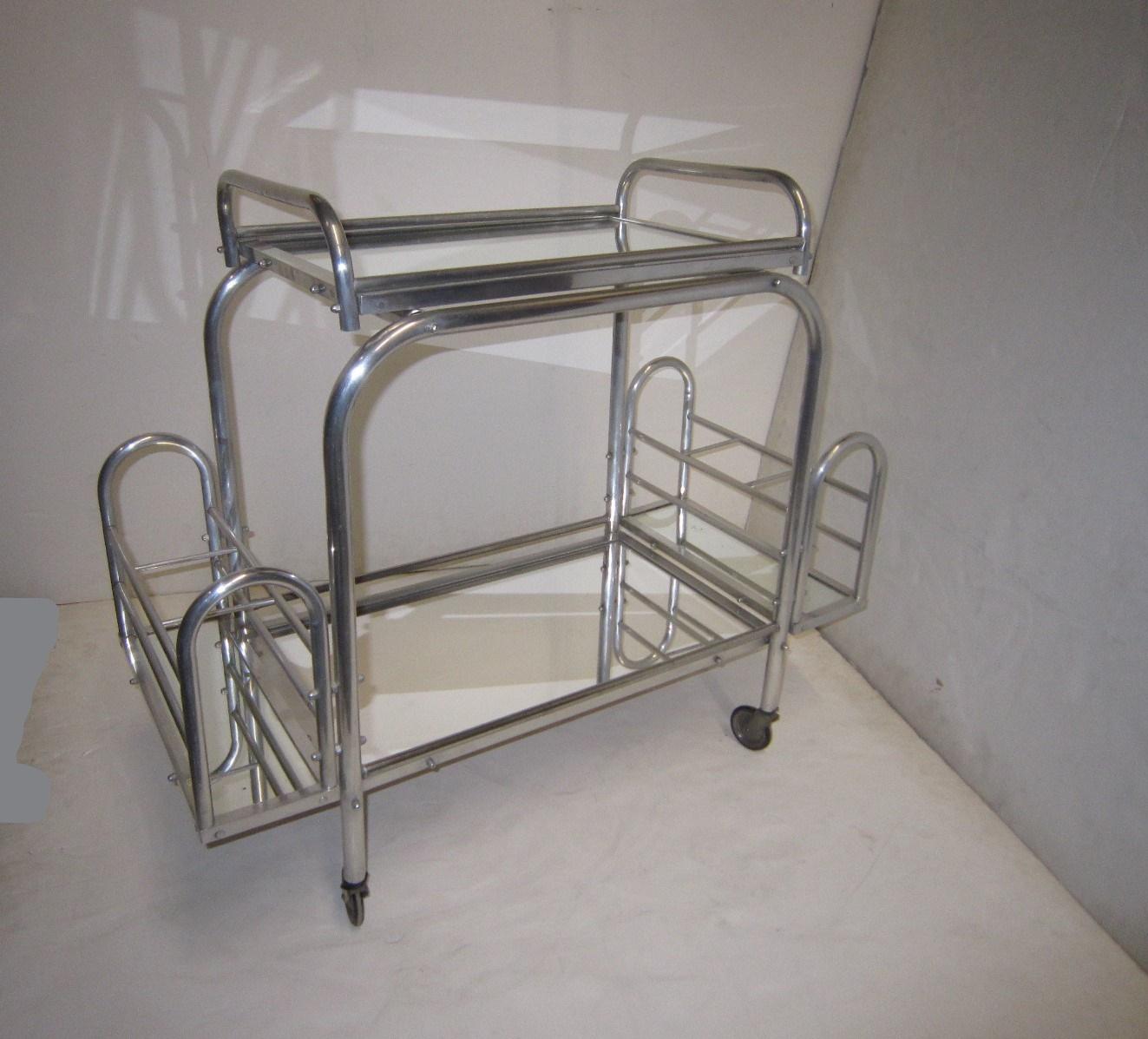 A lovely French Art Deco tubular chrome and mirror serving cart or trolly with removable tray by Jacques Adnet.
All original components intact with nothing missing: removable tray, two side compartments for bottles and storage,
and original