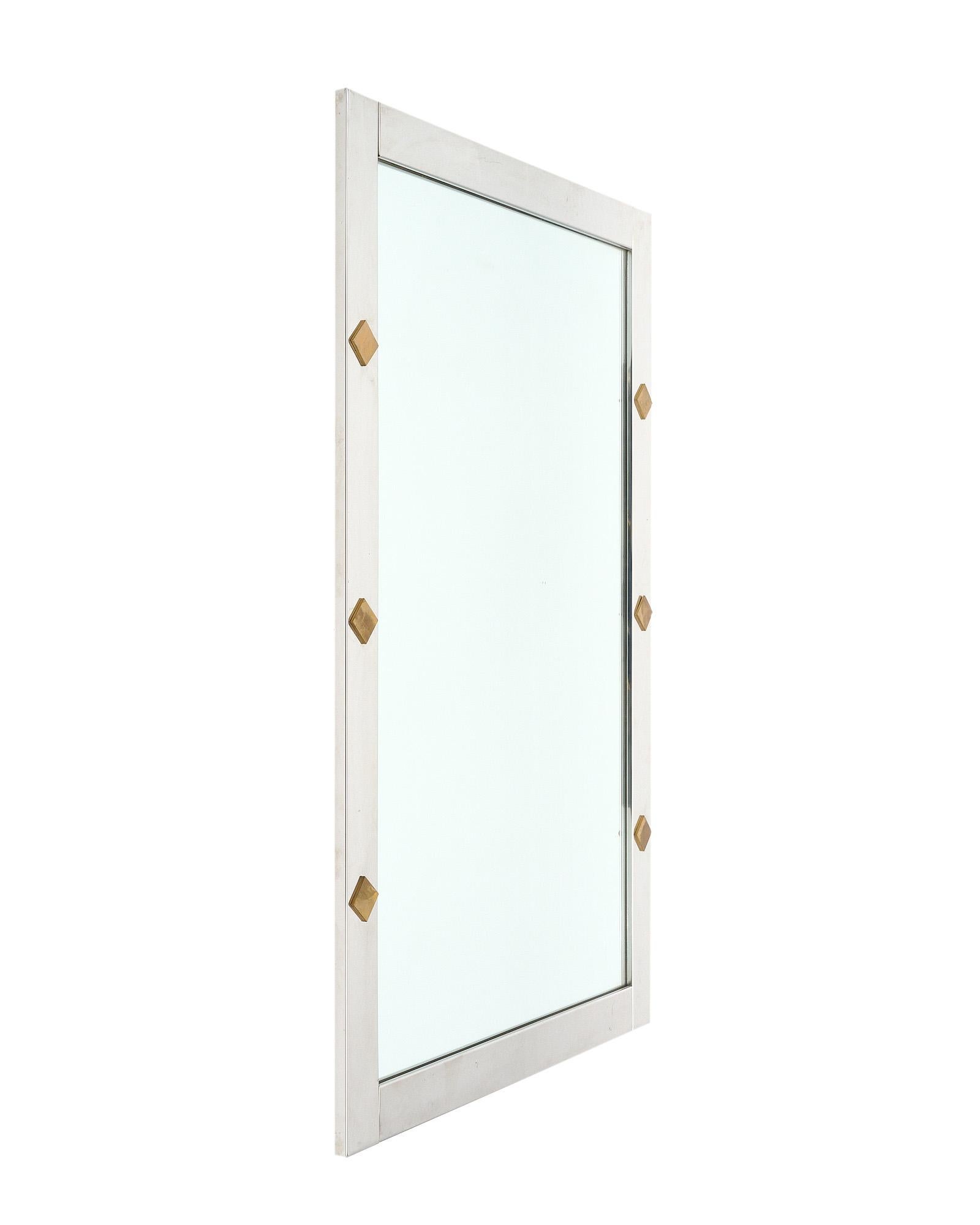 Mirror from France with a chrome, sleek frame adorned with brass square components. The interior rectangular mirror is original.
