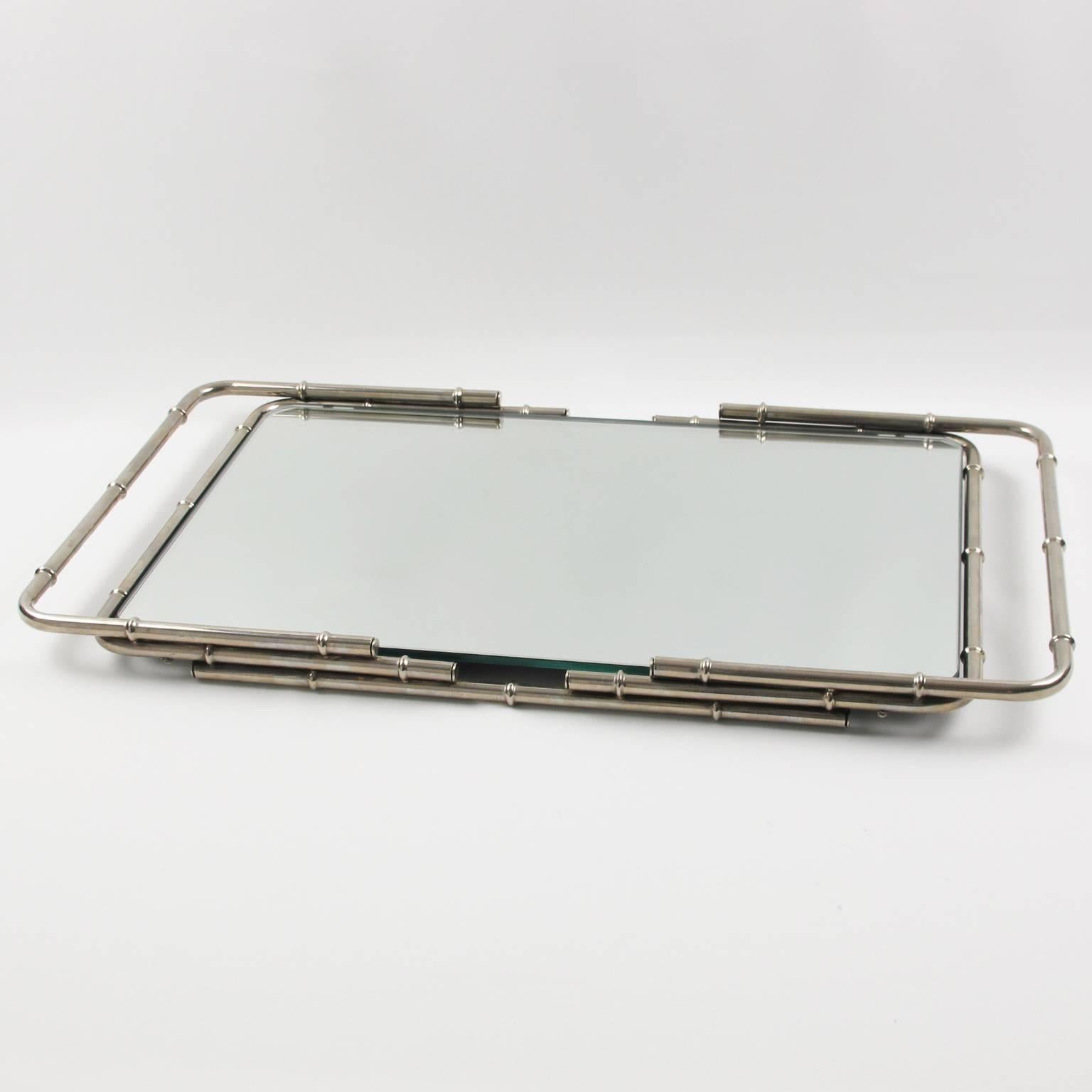 Elegant serving tray for a bar, cocktail party, vanity, or simply on its own. Chrome-plated metal frame with mirrored glass insert and bamboo carved pattern handles and gallery.
Measurements: 21.25 in. wide (54 cm) x 12 in. deep (30.5 cm) x 1.38