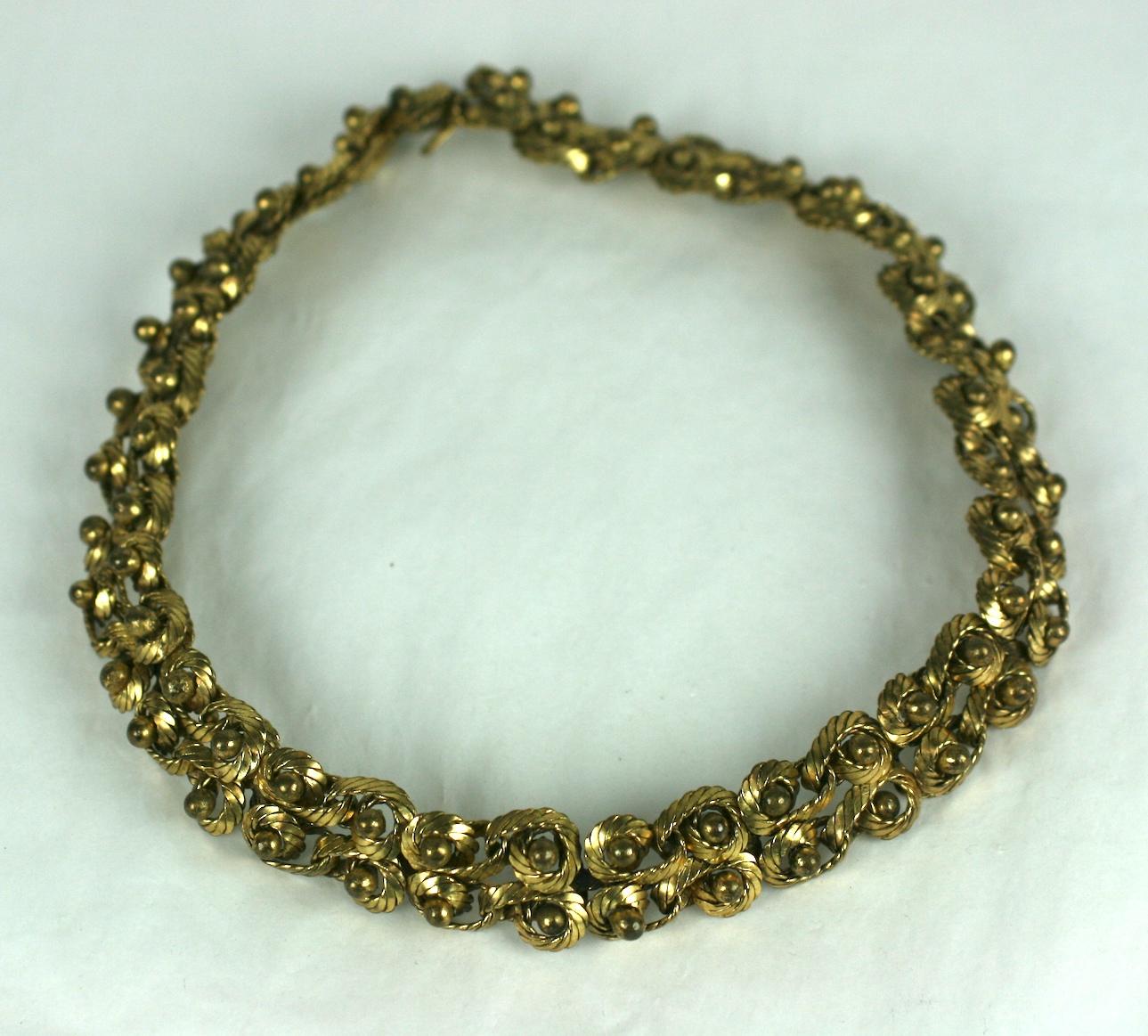 Unusual French Modernist twisted coil upon coil intricate woven necklace. There are four rows of gold plated textured metal wire with the center of each coil having a tiny hand applied gilt ball. France 1950's. Handmade.
Excellent Condition.
Length