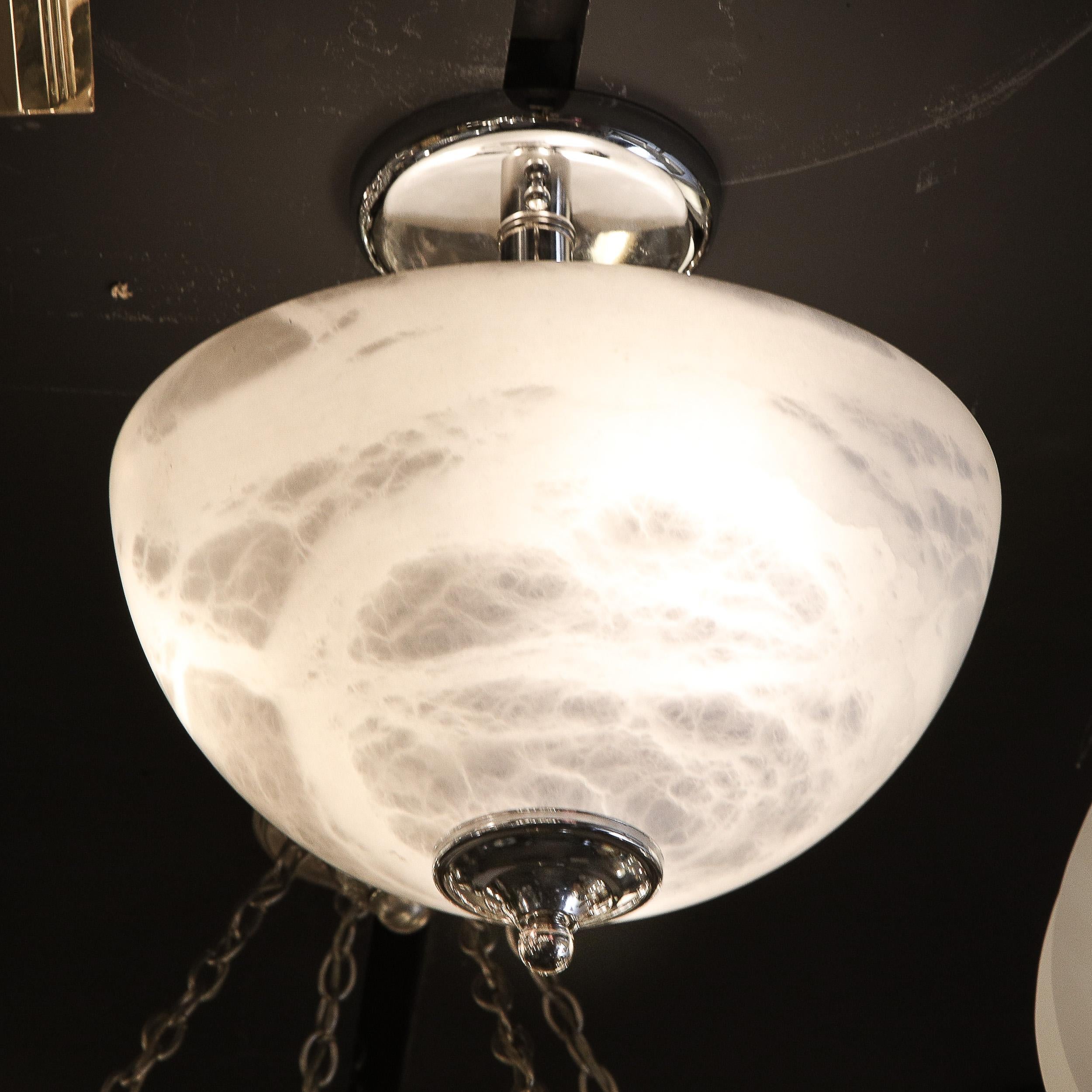 This elegant modernist alabaster and chrome flush mount chandelier was realized in France during the latter half of the 20th Century. It features a domed bullet form shade in sumptuous white alabaster displaying a particularly dramatic and high