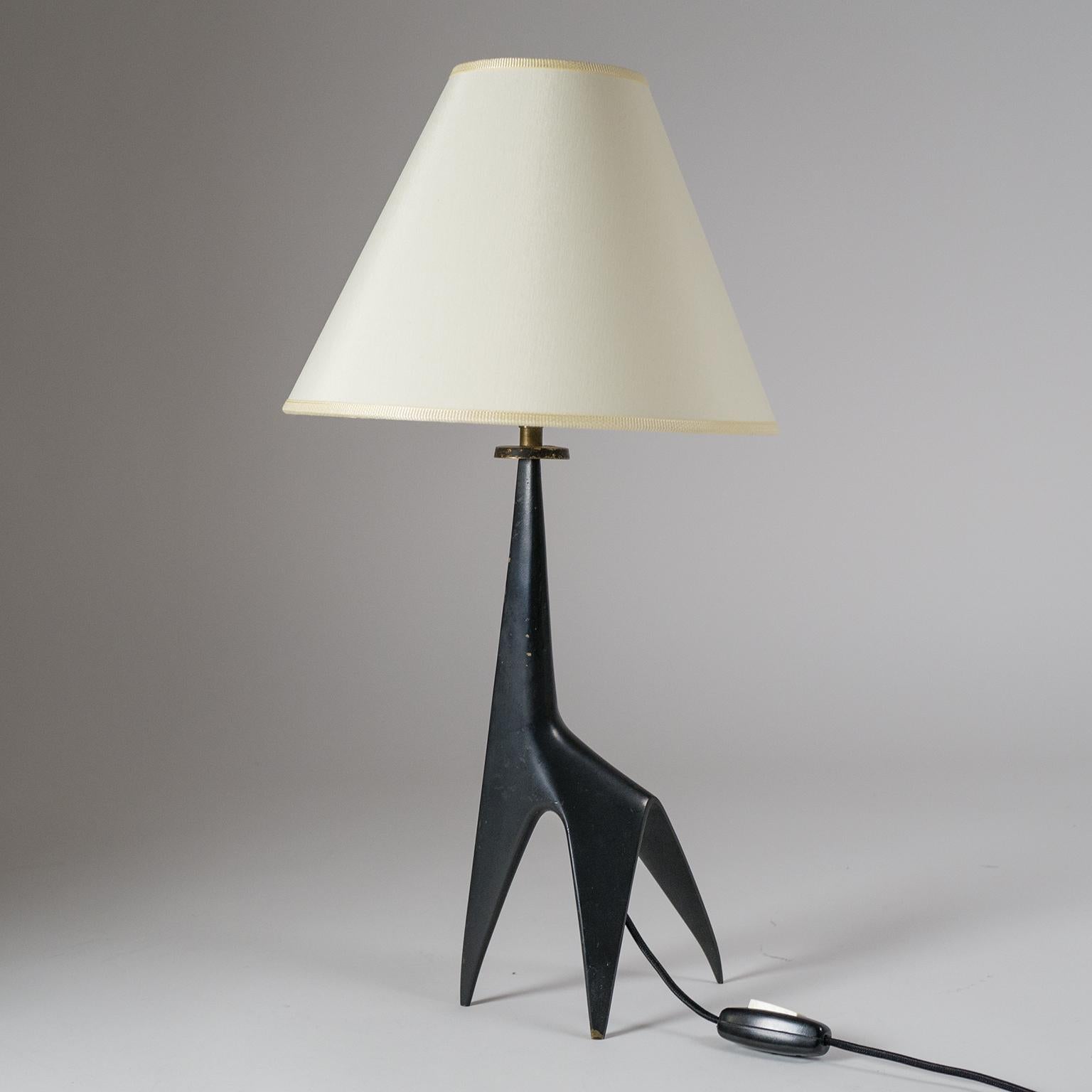 Superb minimalist French 'Giraffe' table lamp from the 1950s. The black lacquered cast bronze base is a sensuously curved fusion of a tripod with a giraffe silhouette, and one of the finest examples of mid century French 'zoomorphic' tradition. Some