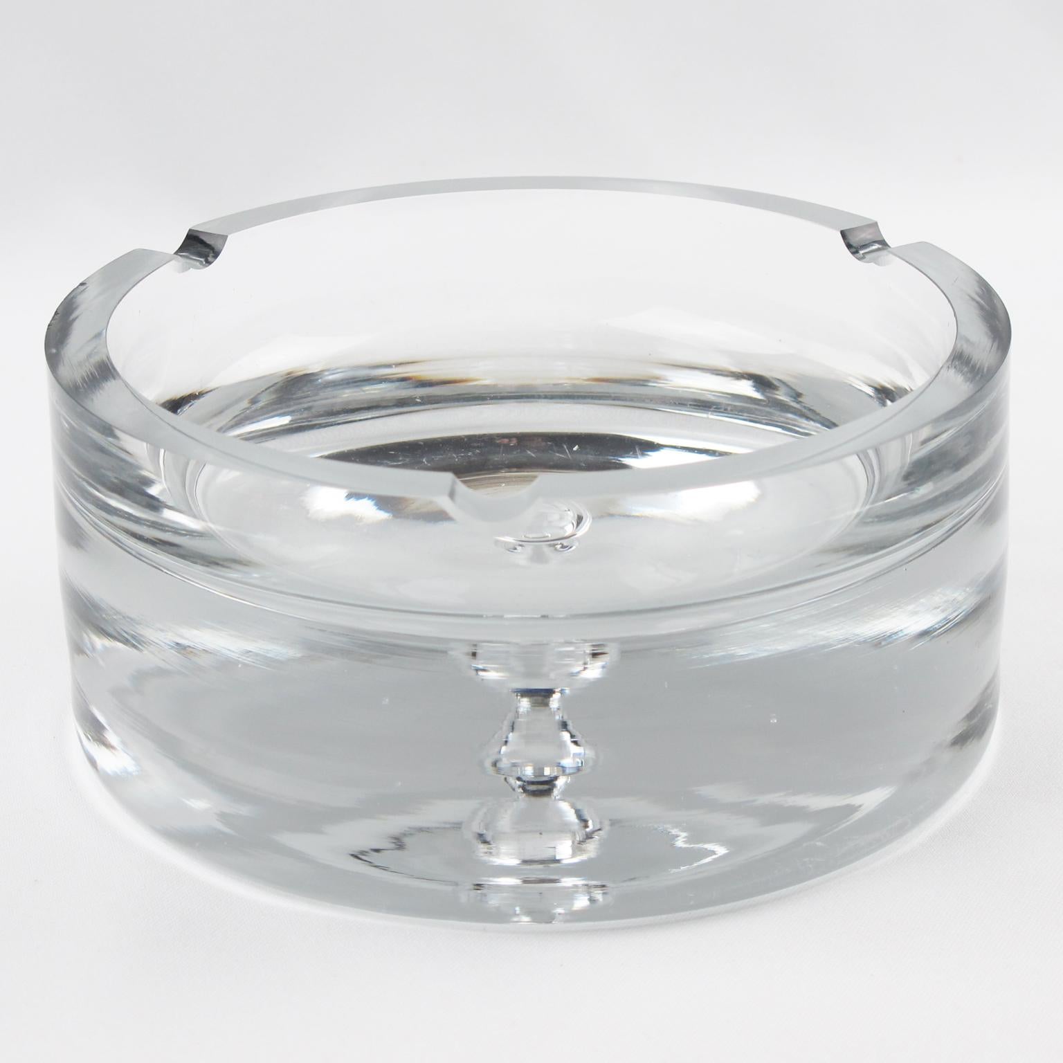 Stunning large midcentury modernist glass cigar ashtray or desk tidy or vide poche. Extra thick handmade crystal clear glass, rounded shape with blown bubble insert in the middle.
Measurements: 6.32 in. diameter (16 cm) x 2.94 in. high (7.5 cm).
