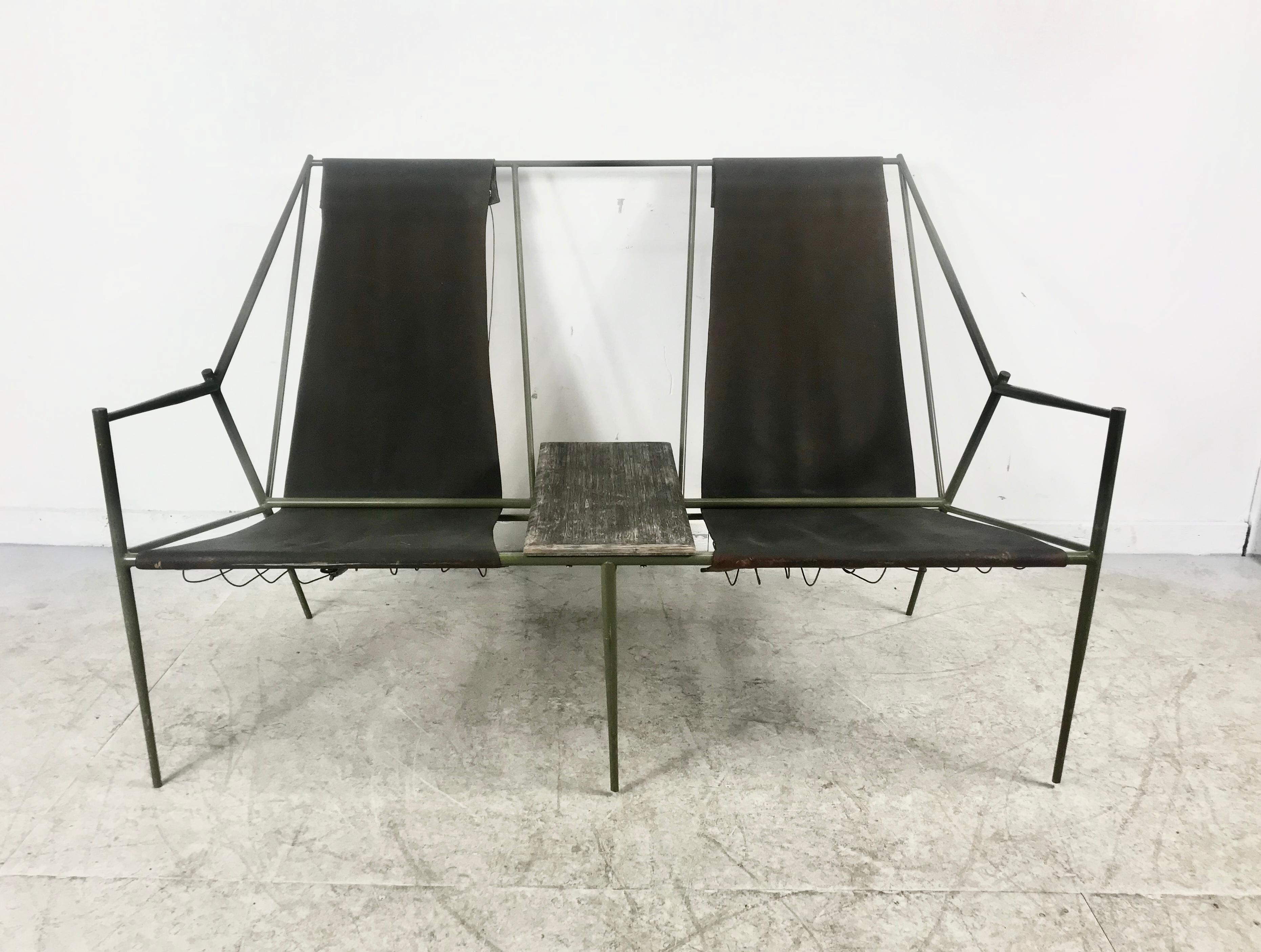 Stunning French modernist iron / leather two-seat sling garden seating with center table. Stunning design, sculpture, reminiscent of amazing designs by Jacques Adnet. Light moss green painted iron frame, Geometric design. Two leather slings with