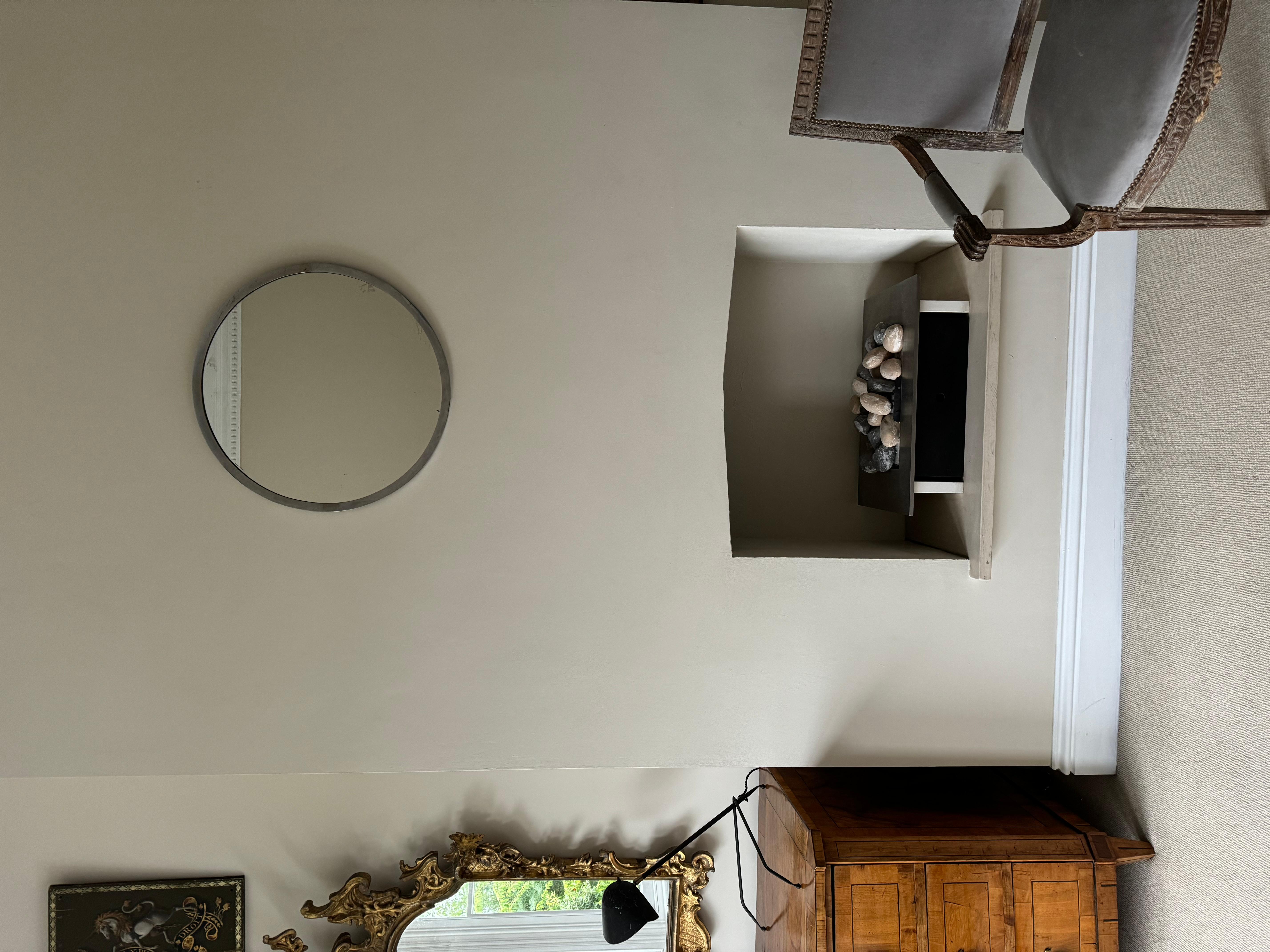 Un elegante specchio circolare modernista francese in ottone e nichel.