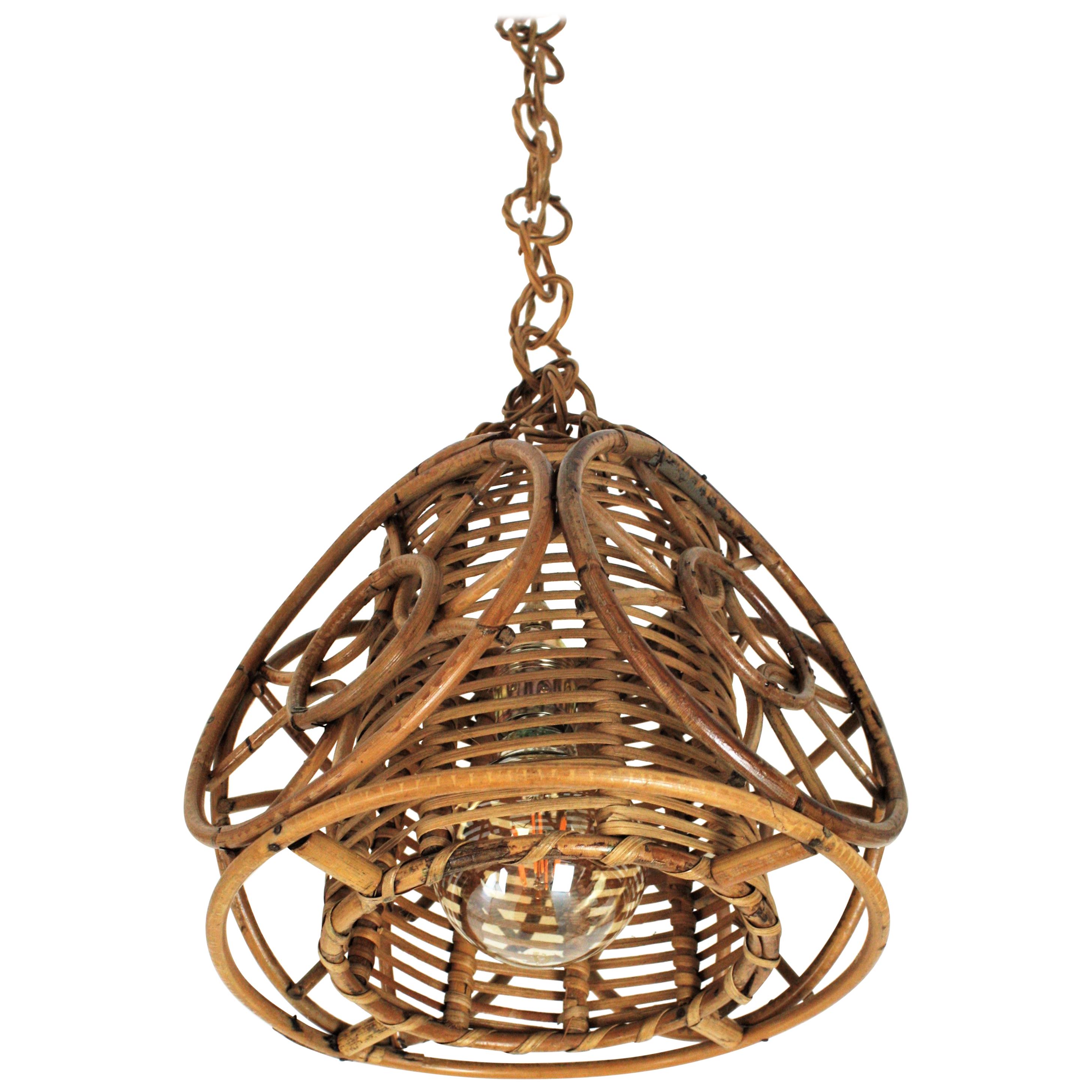 Mid-Century Modern rattan pendant or lantern with wicker inner shade and circles decorations. France, 1950s.
This sculptural pendant with conic shape has an unusual design with an inner cylindrical shade made of braided wicker surrounded by a set