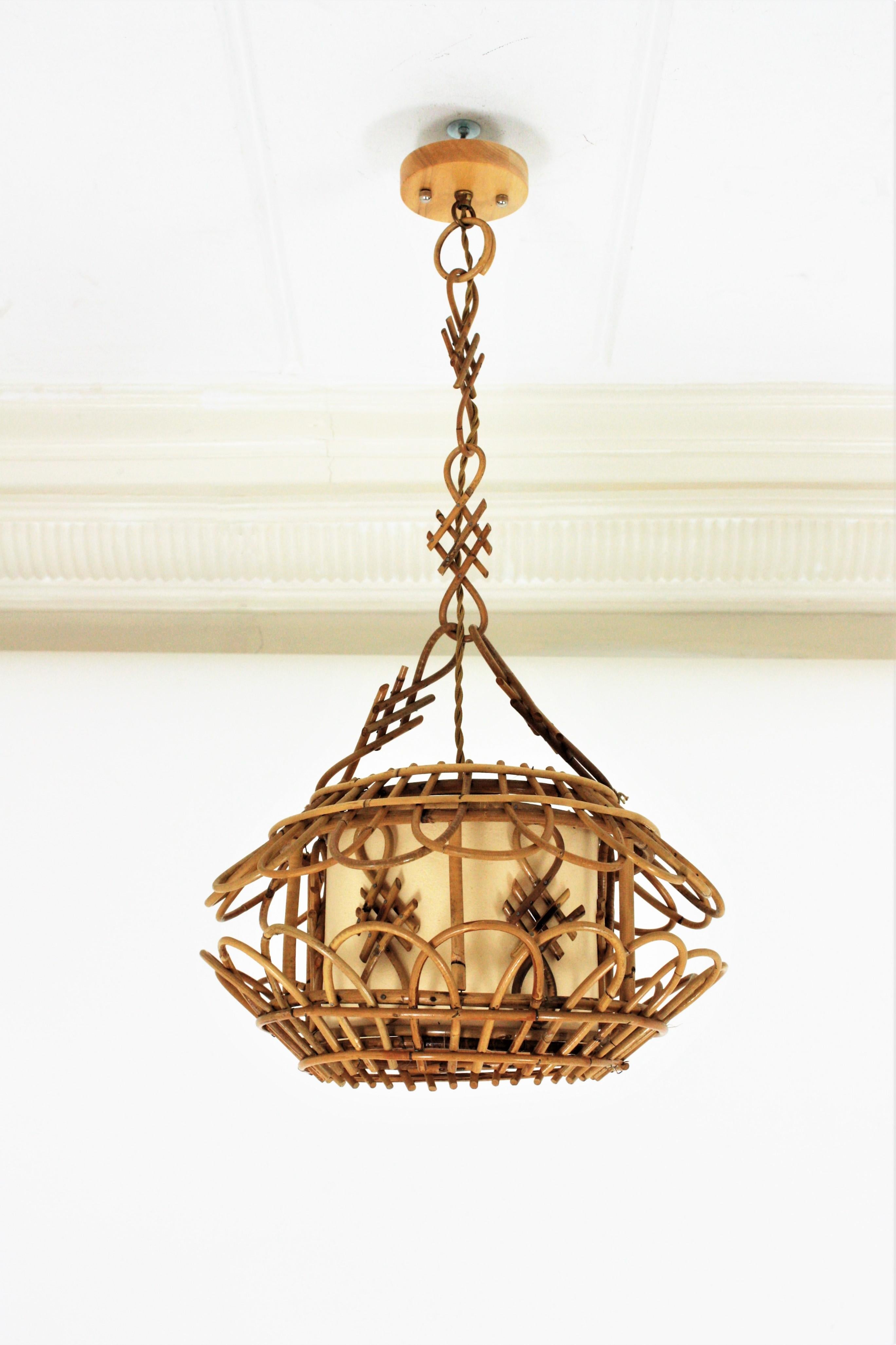 Midcentury Pendant Light or Lantern, Rattan, 1950s
Eye-catching chinoiserie style handcrafted bamboo and Rattan Pagoda shaped pendant lamp / lantern. France, 1950s.
This rattan chandelier features a pagoda shape rattan hanging lamp with oriental