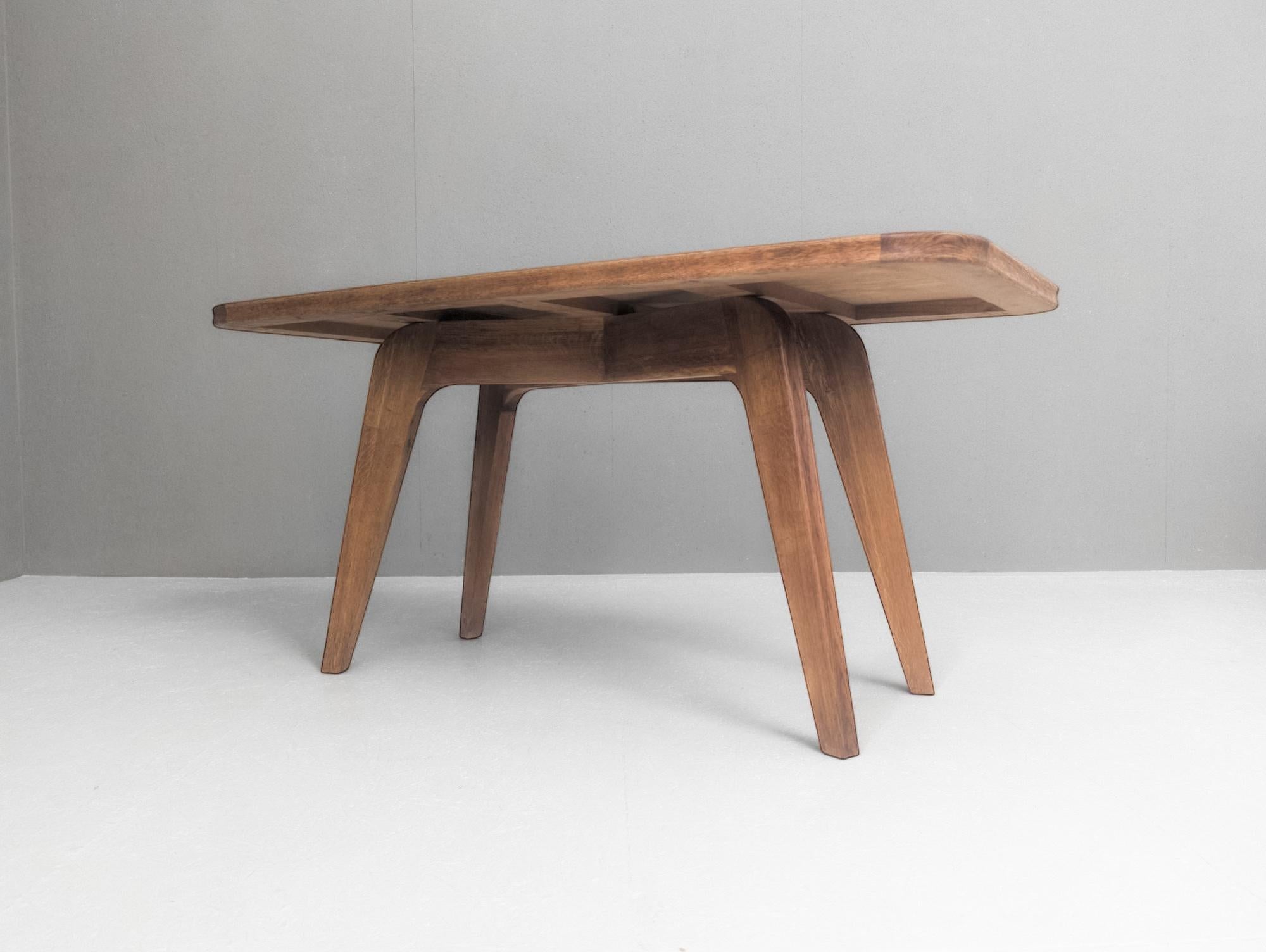 Exemple frappant du modernisme français de l'entre-deux-guerres, cette table en chêne sculpté des années 1930 allie clarté structurelle et équilibre sculptural. Bien que son concepteur reste inconnu, ses proportions et ses détails suggèrent