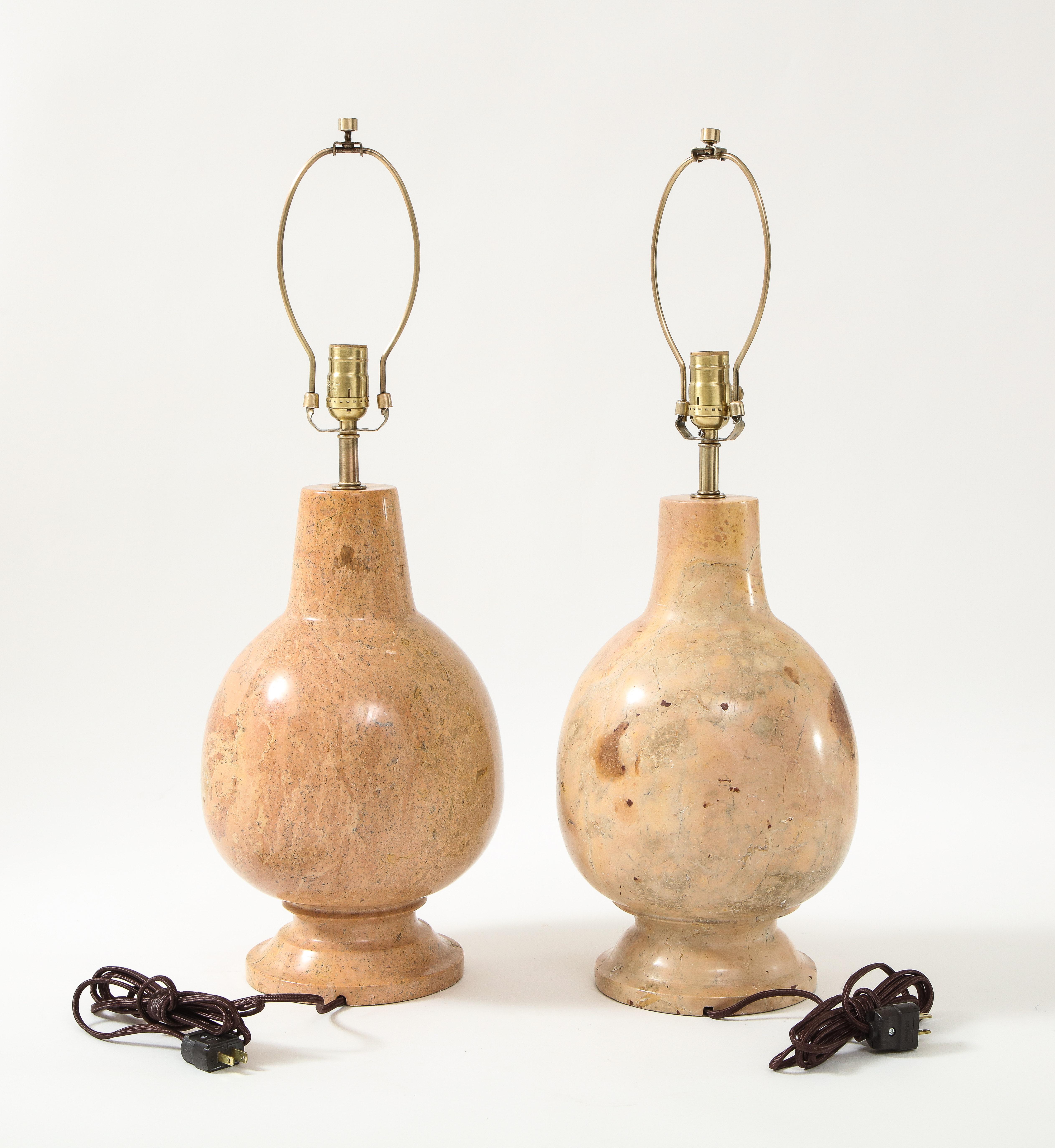 Pair of handmade Italian polished solid marble lamps with a bulbous form. Marble is a fantastic mix of beige neutrals and sandy tones. Rewired and sockets converted for use in USA using brass hardware.
Minor wear to bottoms.