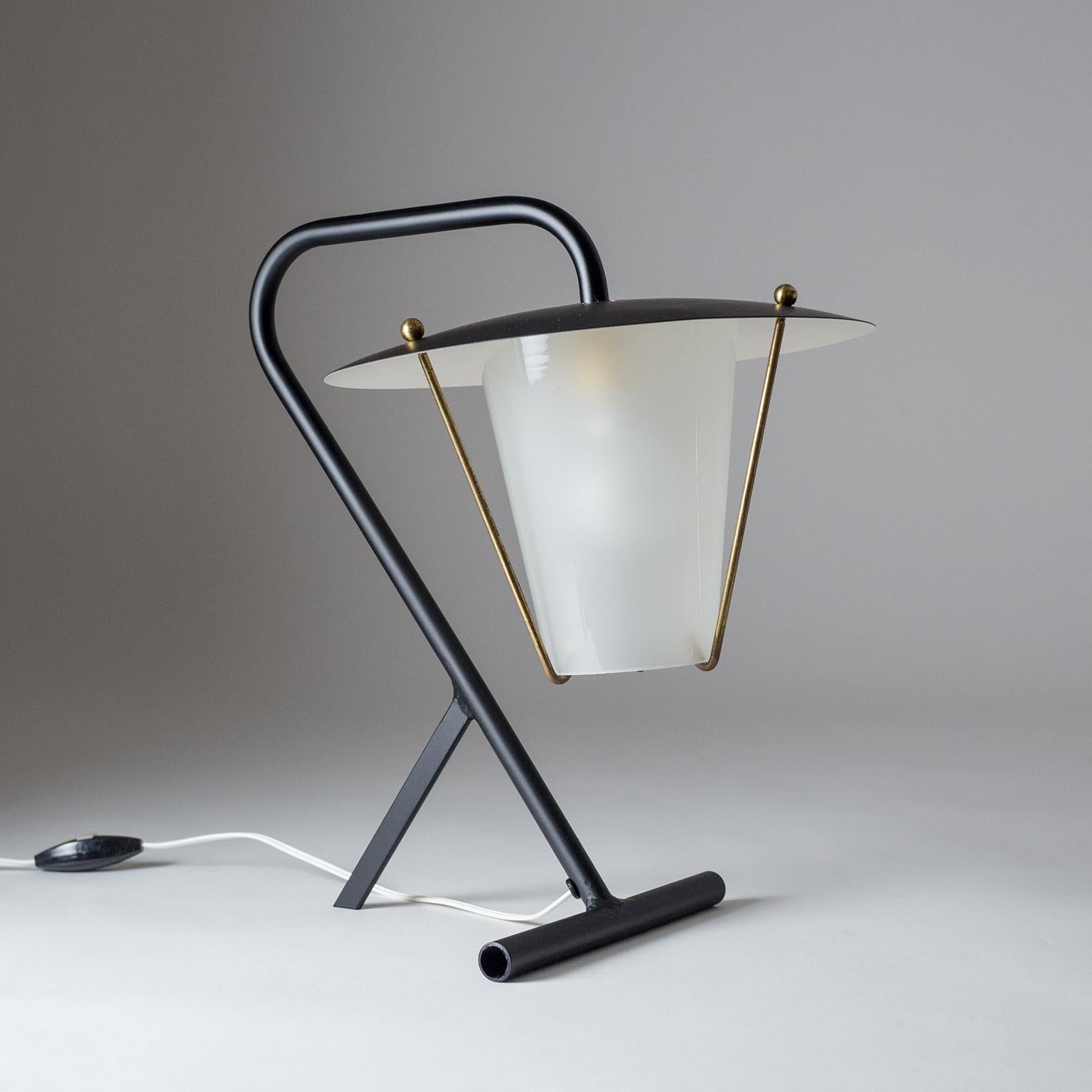 Brilliant modernist French table lamp from the early 1950s. The Minimalist sculptural base holds a lantern style body with glass diffuser (frosted on the inside). One brass and ceramic E14 socket with original switch and plug.