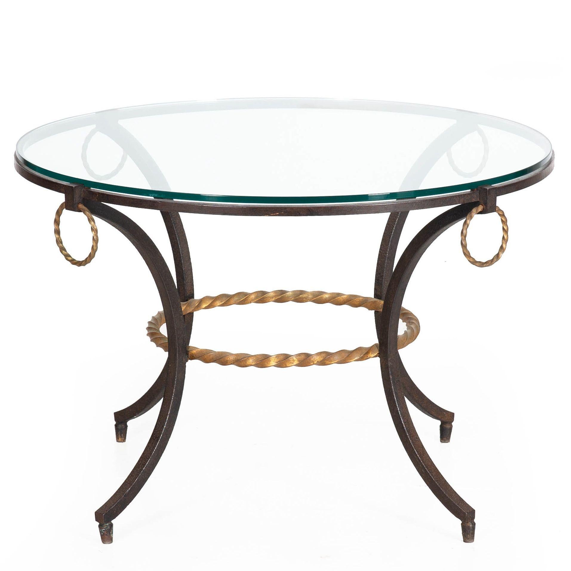 MODERNIST PATINATED WROUGHT-IRON AND GLASS COFFEE TABLE
French, circa 1950s  unmarked
Item # 401RGG02P-2

A captivating modernist table from the 1950s, this piece is versatile, ideal as either a side table next to a low sofa or chair, or as a coffee