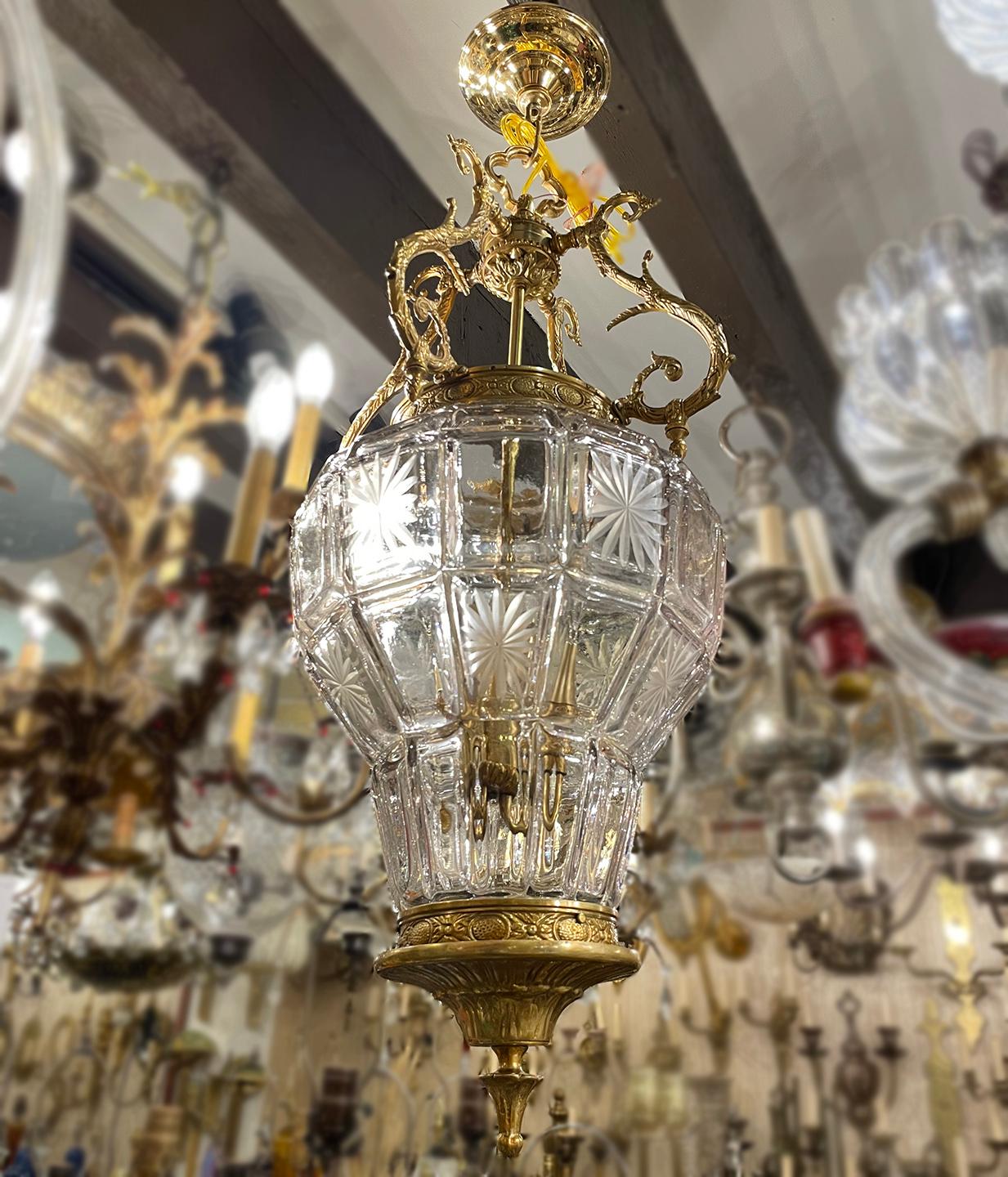 A circa 1920's French molded glass lantern with etched star details on body and three interior candelabra lights.

Measurements:
Height: 34