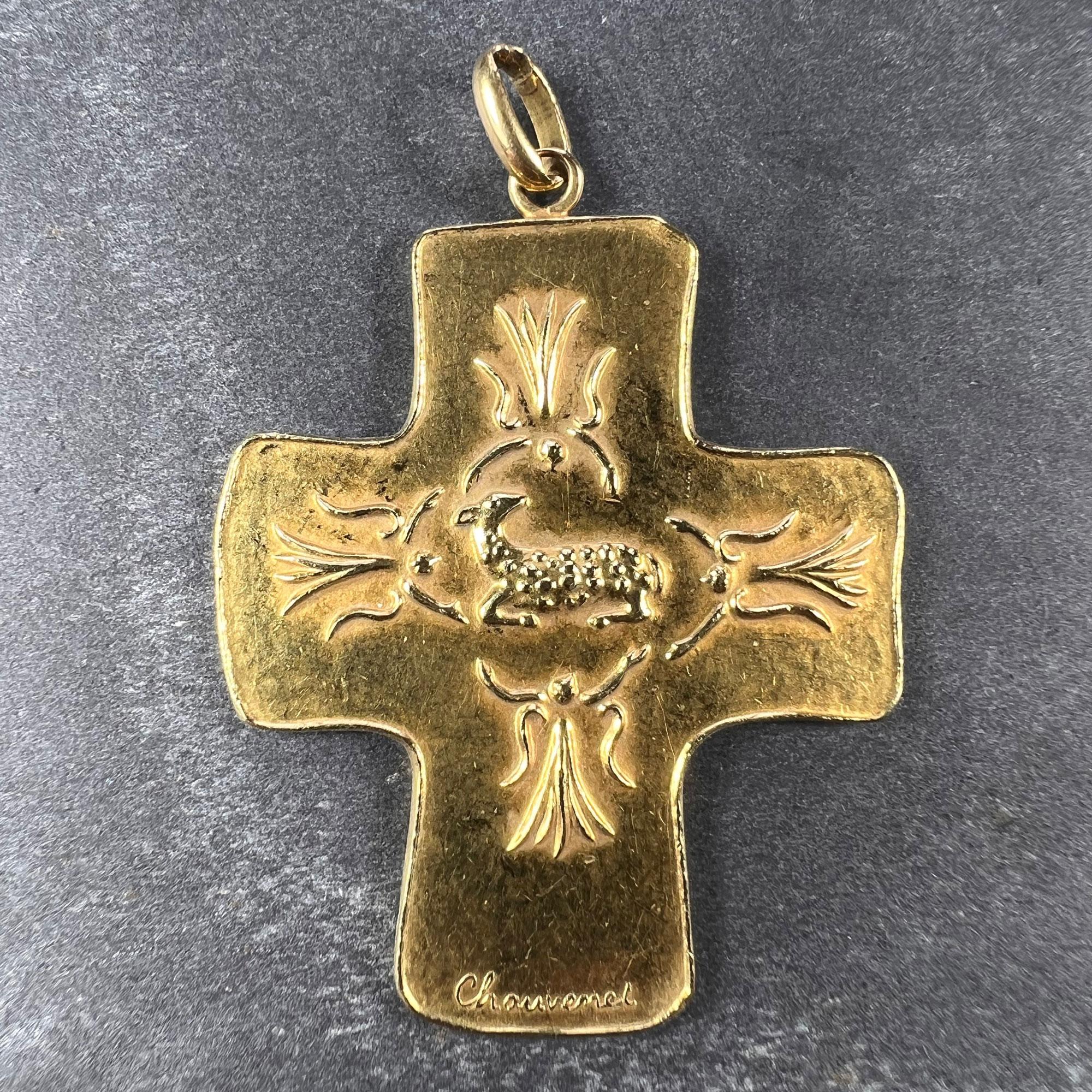 An 18 karat (18K) yellow gold pendant designed as a cross with an abstract depiction of the Lamb of God to the centre surrounded by angels. Signed Chauvemet, numbered #3 and stamped for the Monnaie de Paris (the Paris Mint Museum). Tested for 18