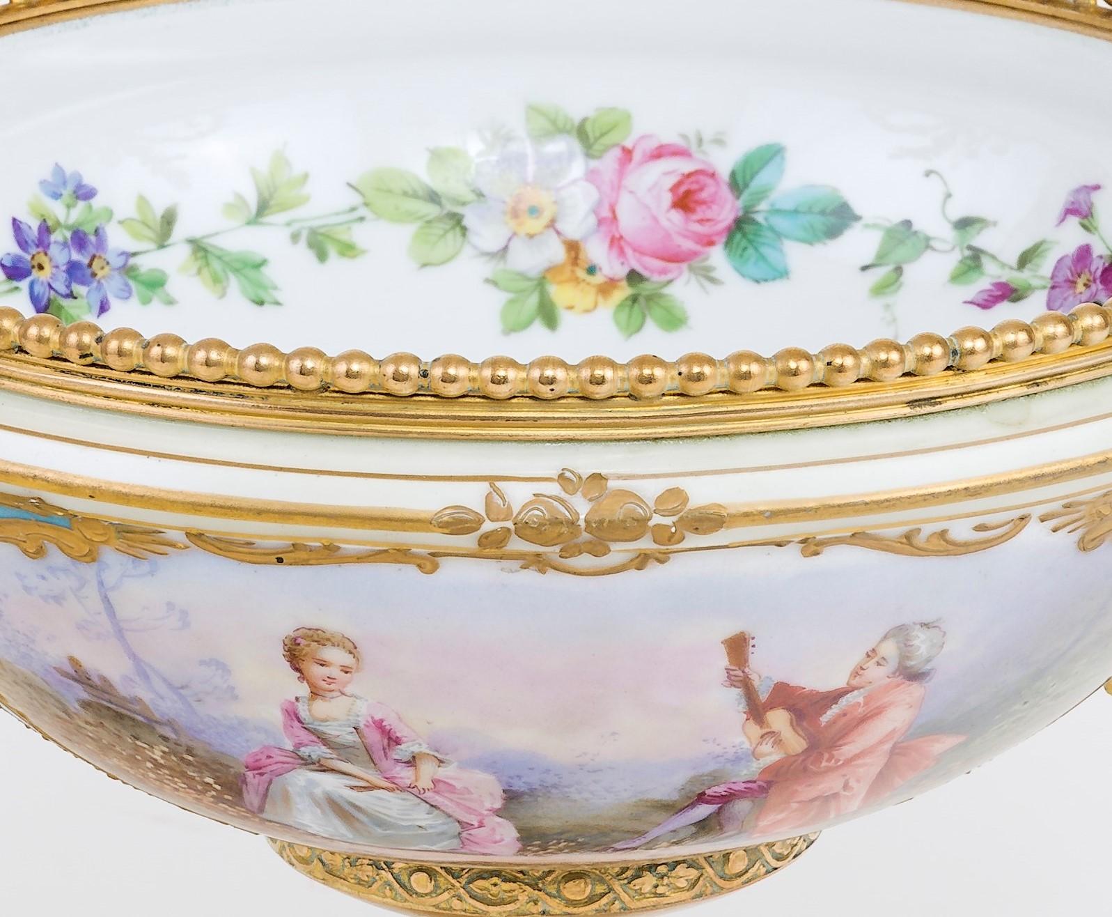 This French Sèvres Porcelain centrepiece from 1771 is set in gilt bronze mount 'ormolu'. The bowl itself displays one medallion on turquoise background with a pastoral scene of a couple in nature, the gentleman playing the guitar for the lady. This