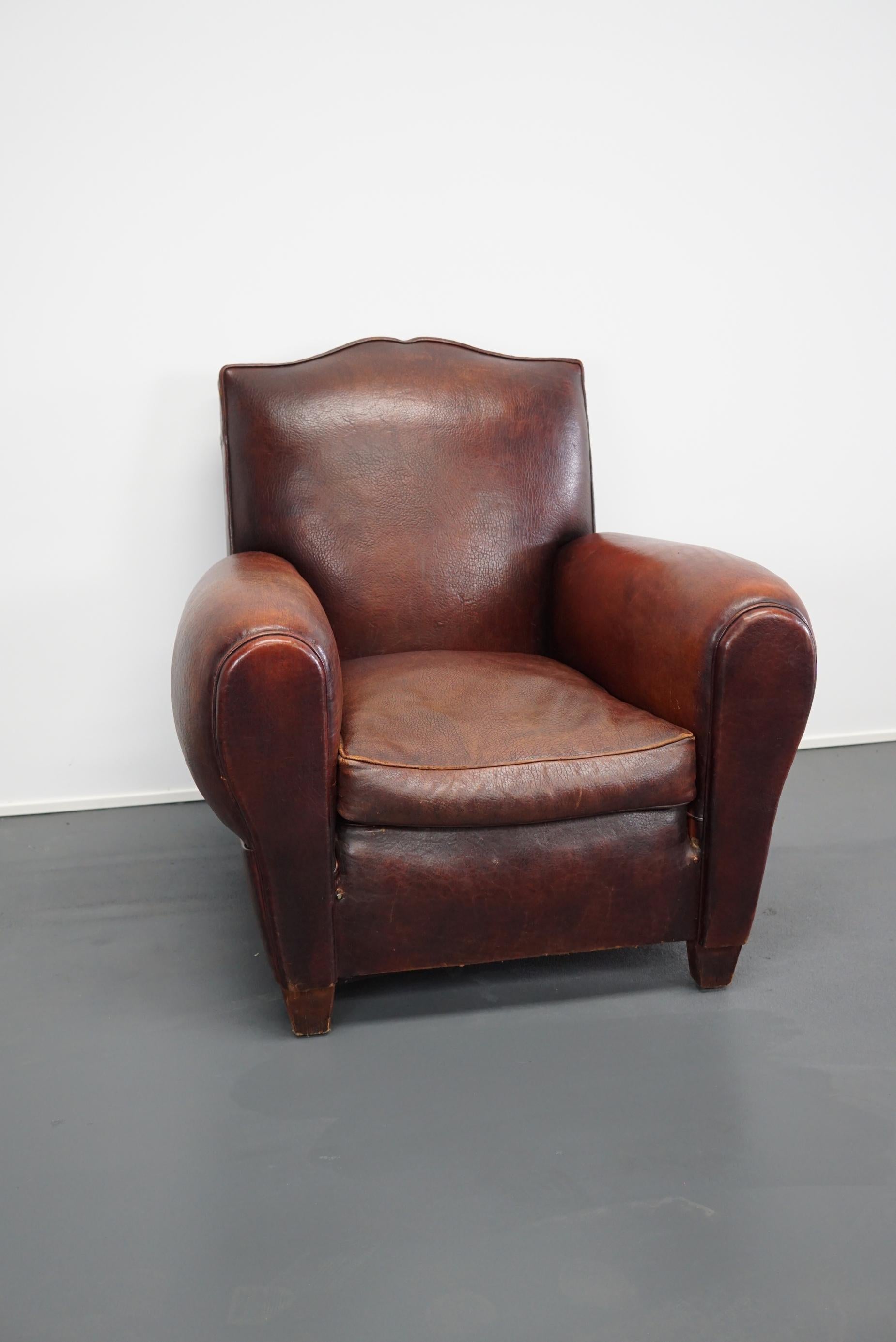 This moustache back French leather club chair was designed and made in France. It is in an amazing condition for it's age. The thick buffalo hide upholstery makes it stand out.