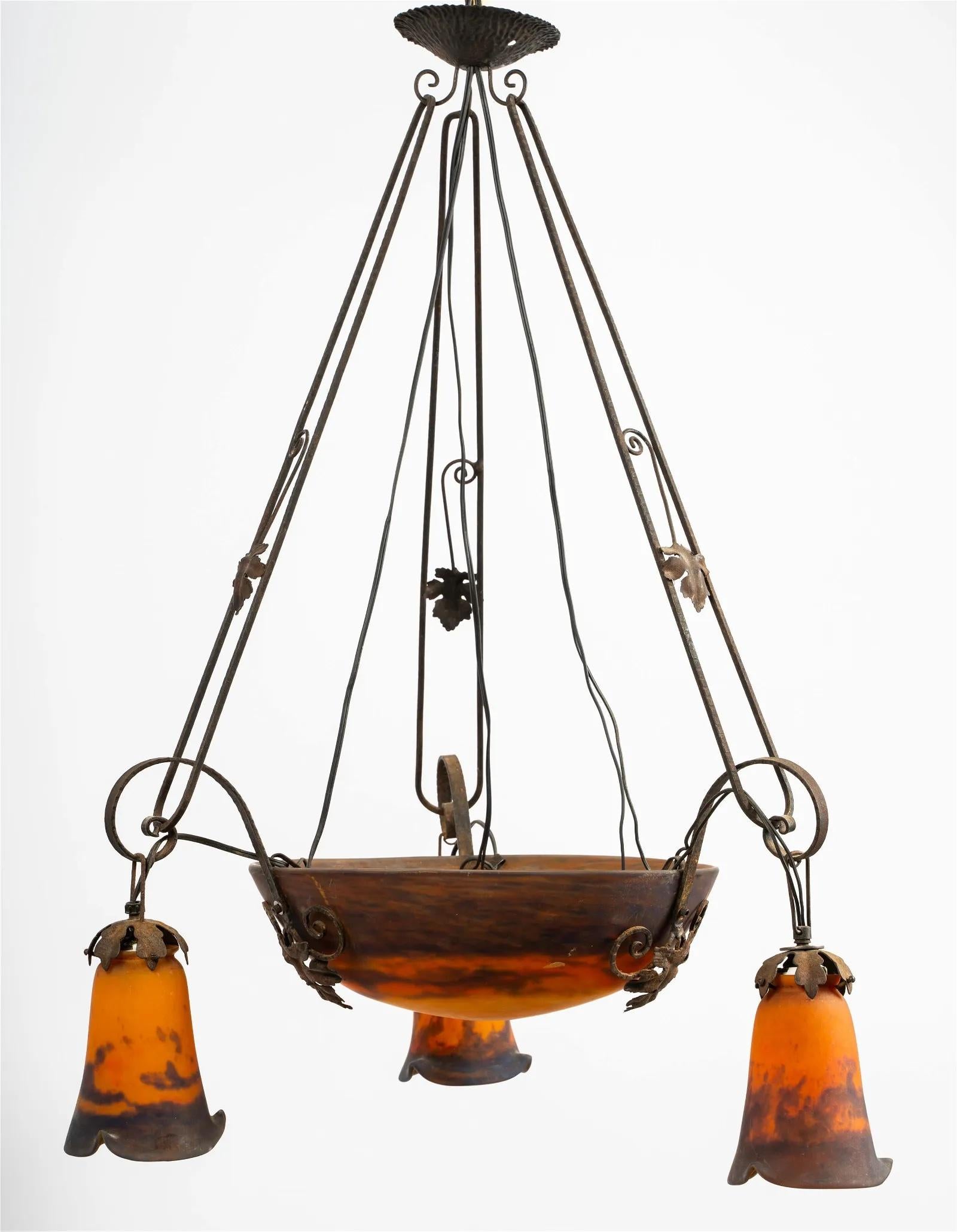 Circa 1900 French Art Nouveau Muller Freres Luneville Art Glass Chandelier. Signed glass shades. The metal frame with three arms suspending a mottled orange and purple bowl fitted with three candelabra sockets on the interior, and three conforming