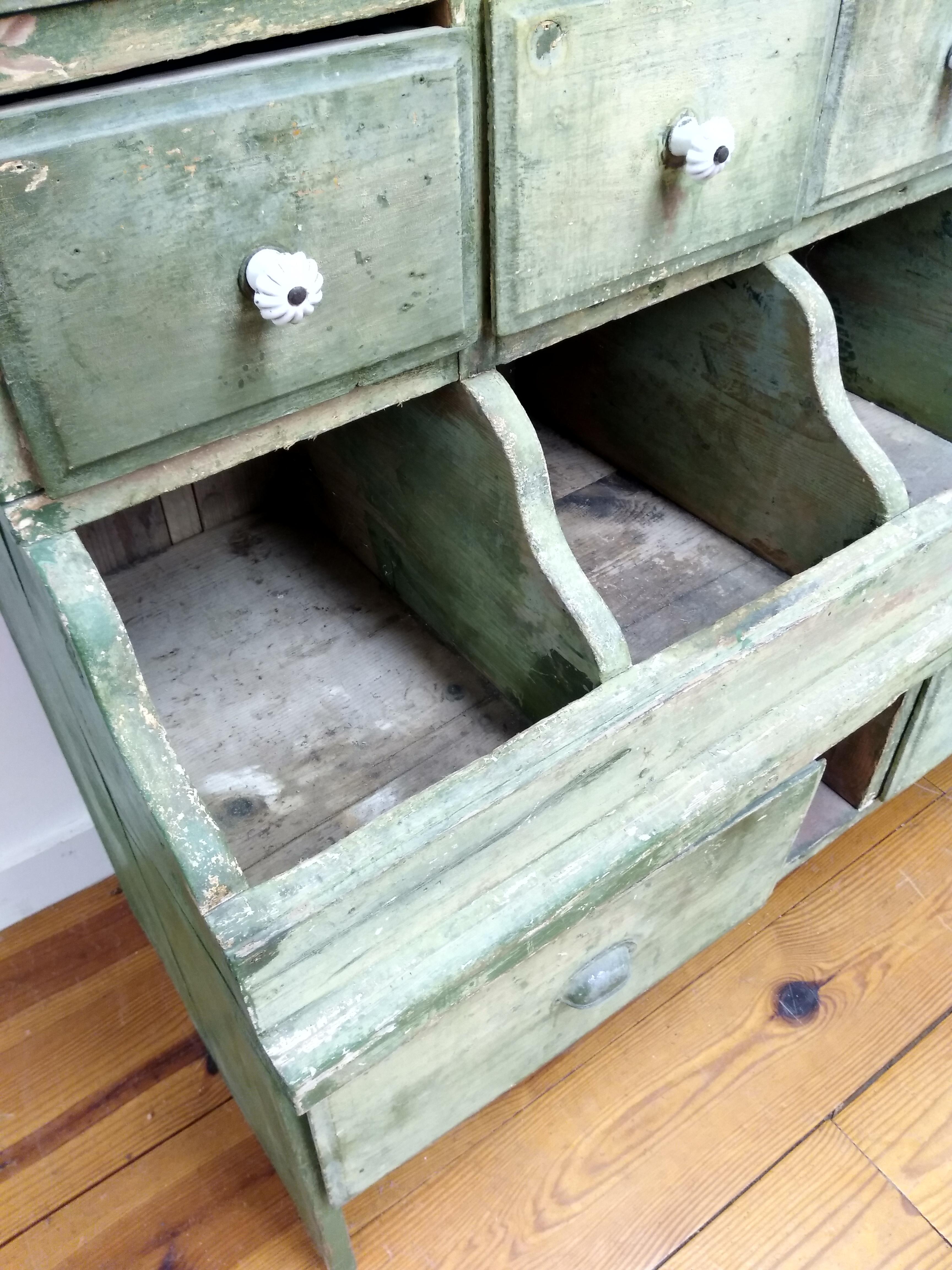 What is better: the original green paint or the architecture of this multi-drawer cabinet? This large wooden piece, made in 1910, was used to hold seeds in a French shop. Original glass knobs, too. Simply said, it’s a fantastic show-stopping piece