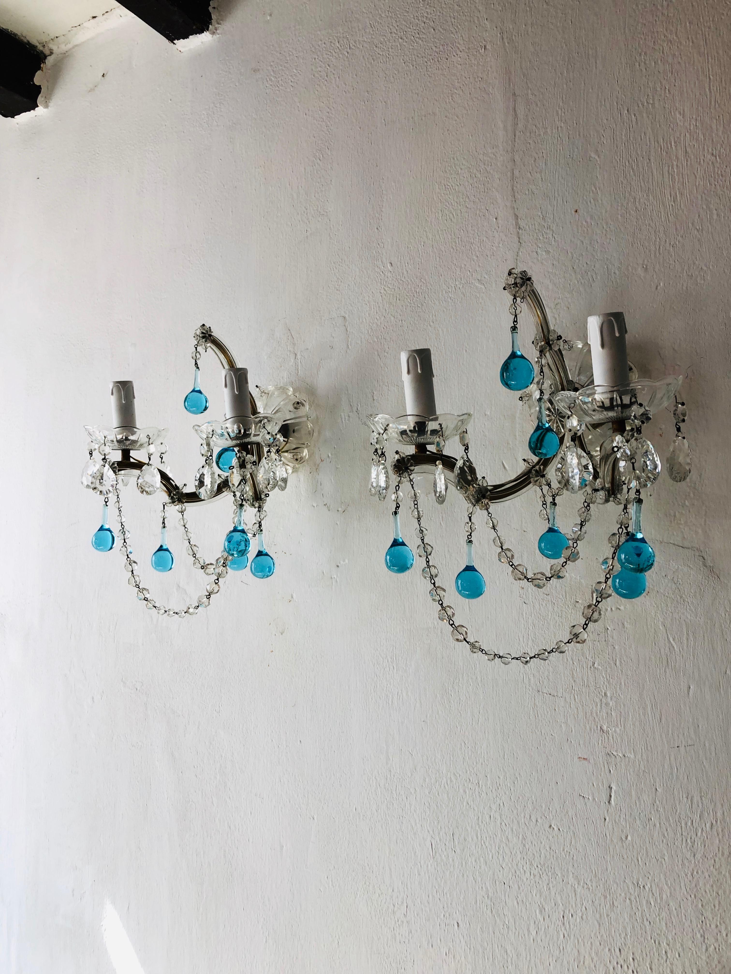 Re-wired and ready to hang! Housing two lights each, sitting in crystal bobeches dripping with vintage crystal prisms. Adorning Murano aqua drops, florets and crystal swags. Huge bobeche as back plate. Free priority shipping from Italy.