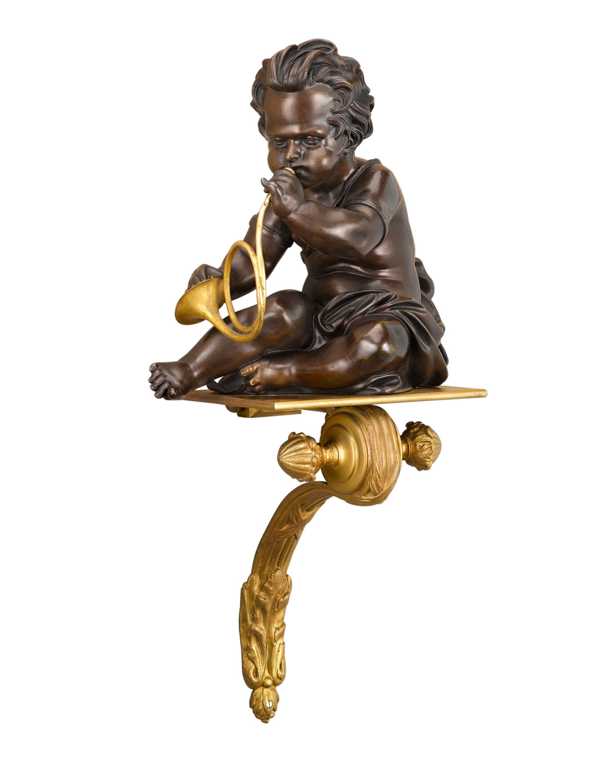 A duo of musically inclined putti plays a horn and cymbals in this rare and attractive pair of French wall brackets. The patinated bronze putti rest upon fine doré bronze platforms of elegant scroll form. circa 188022 3/4” high.