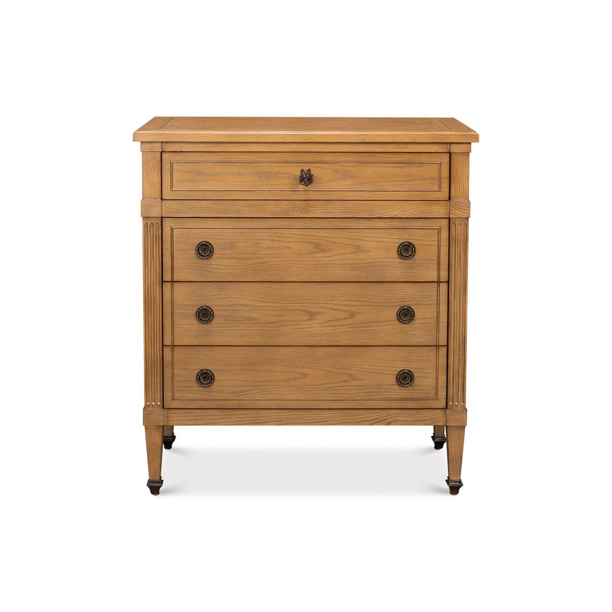 Mahogany in a light finish with oak-lined drawers. Four drawers with neo-classic hardware, fluted styles raised on square tapered legs.

Dimensions: 32