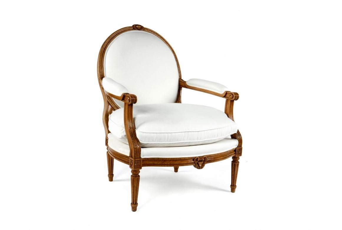 A stunning French Nancy Louis XVI Fauteuil armchair, 20th century.

The Nancy Louis XVI fauteuil is shown in cherrywood with a Leblon finish. With hand carvings all across the wooden frame, this fantastic piece has an oval back with hand-carved