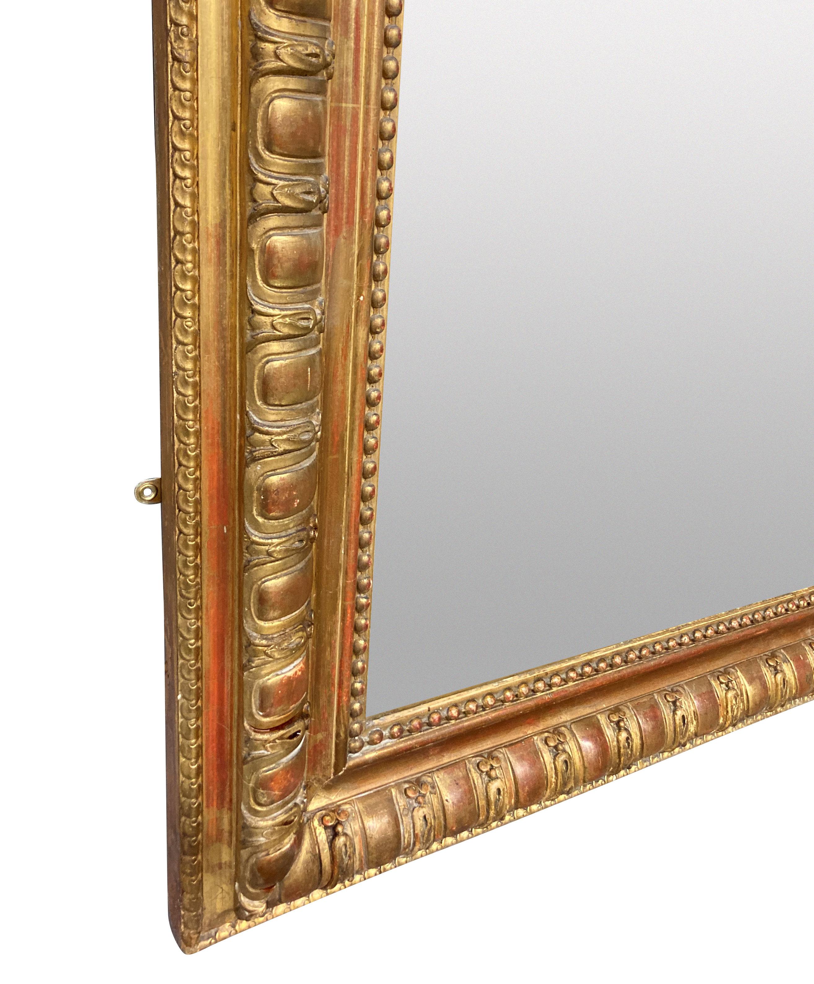 A French Napoleon III finely carved gilt wood overmentle mirror of simple, elegant design, with original plate.