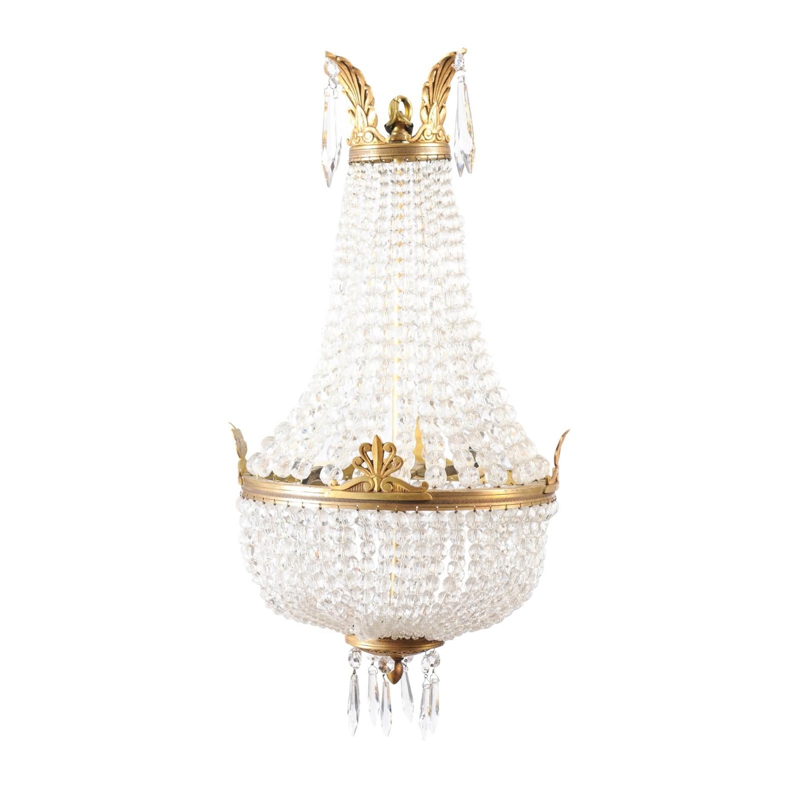 A French Napoléon III period montgolfière two lights crystal chandelier from the mid 19th century with brass foliage, wired for the USA. Experience the allure of French artistry with this mid 19th century Napoléon III period Montgolfière chandelier.