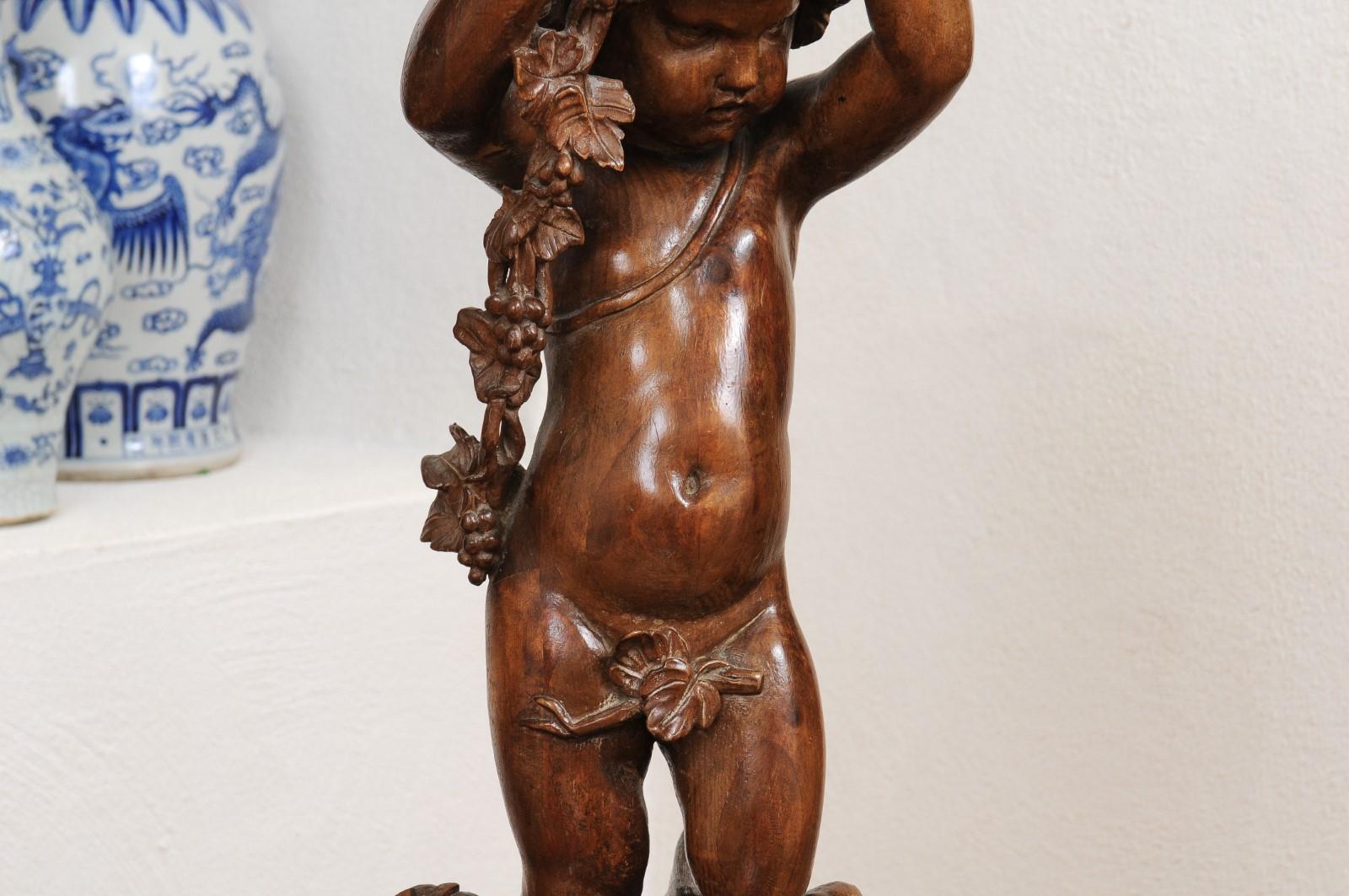 19th Century French Napoléon III 1860s Carved Walnut Sculpture of a Putto Carrying a Vessel For Sale