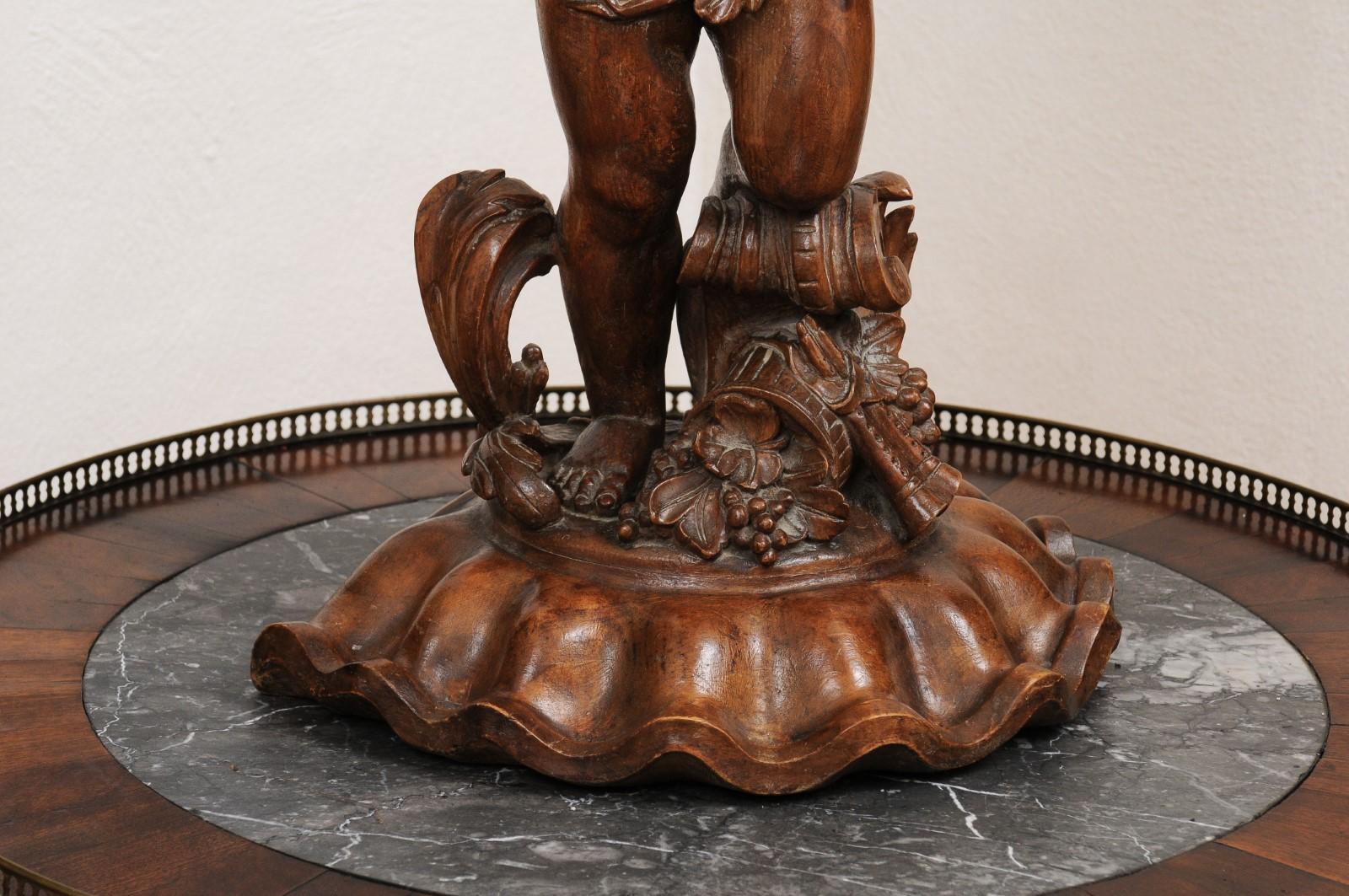 French Napoléon III 1860s Carved Walnut Sculpture of a Putto Carrying a Vessel For Sale 1
