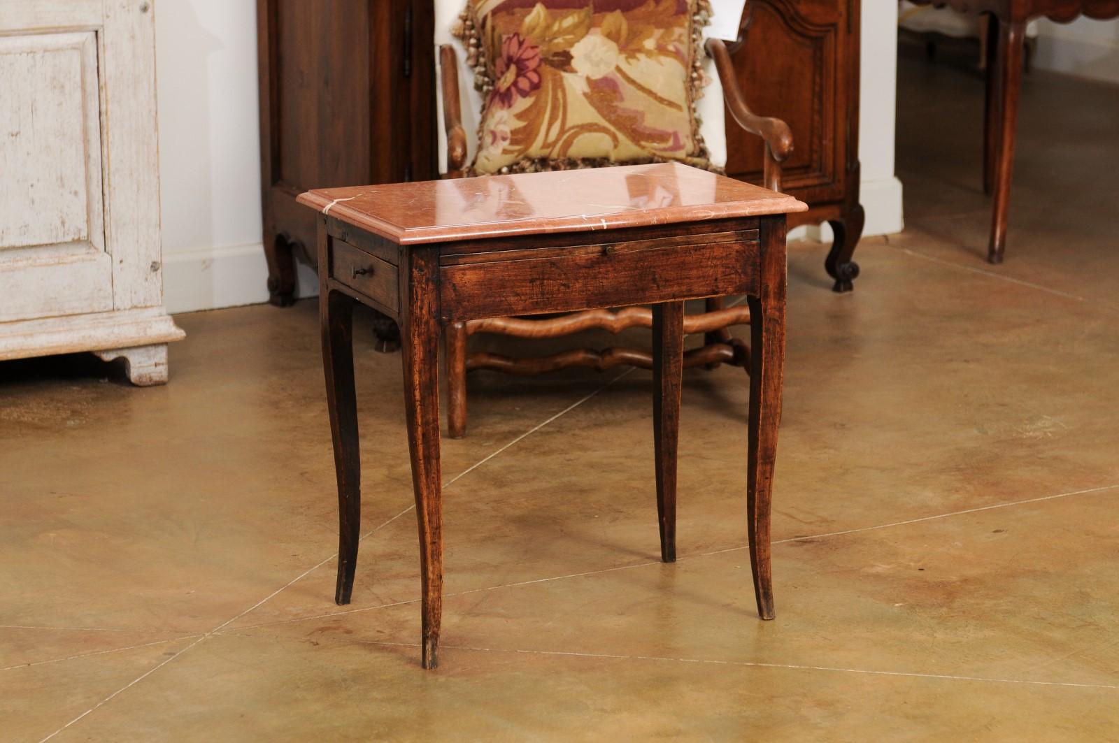 A French Napoléon III period side table from the late 19th century, with red marble top, two drawers and pull-out. Created in France at the end of emperor Napoléon III's reign, this side table features a red veined marble top with serpentine front,