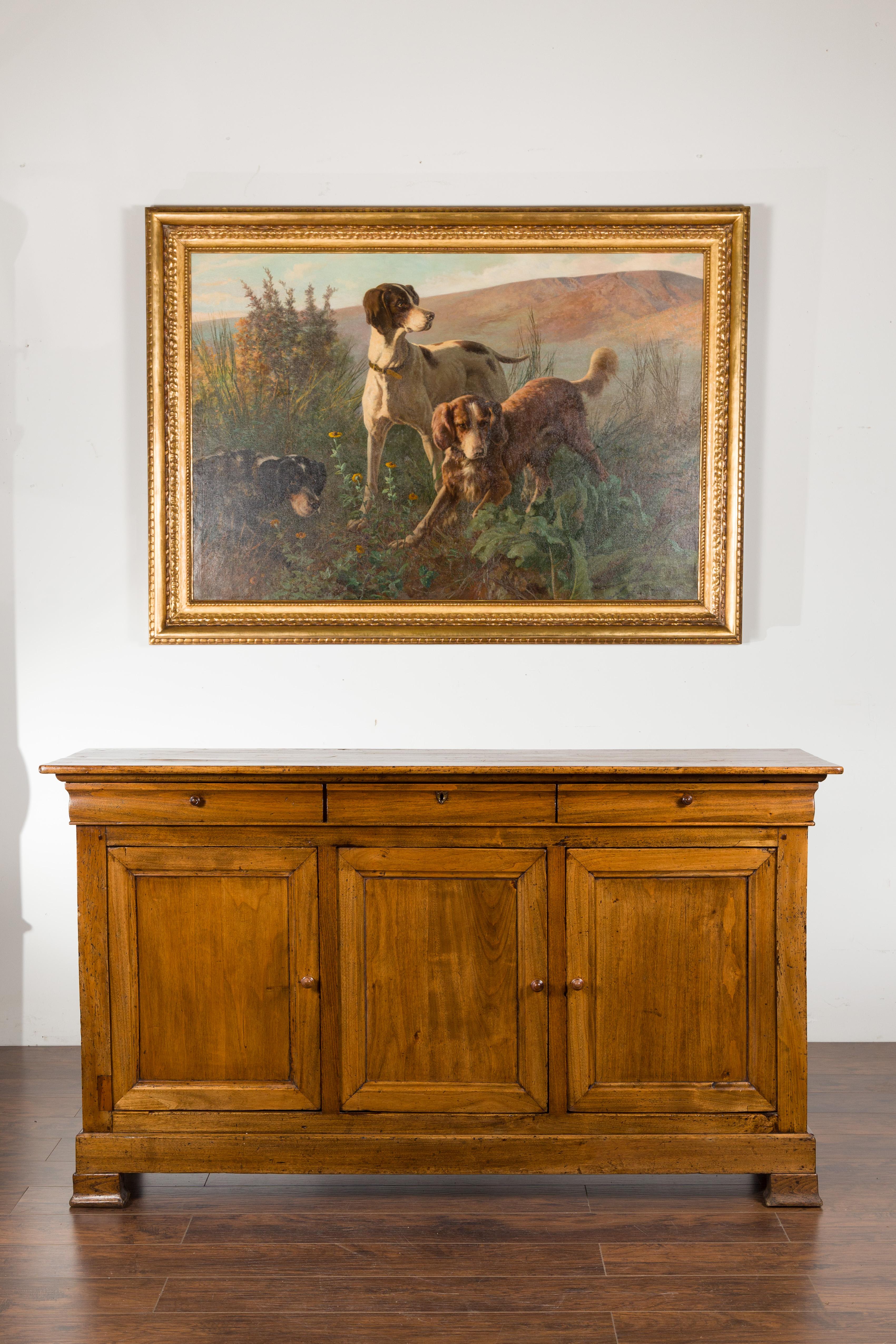 A French Napoléon III period walnut enfilade from the late 19th century, with three drawers over three doors. Created in France during the last quarter of the 19th century, this walnut enfilade features a rectangular planked top sitting above three