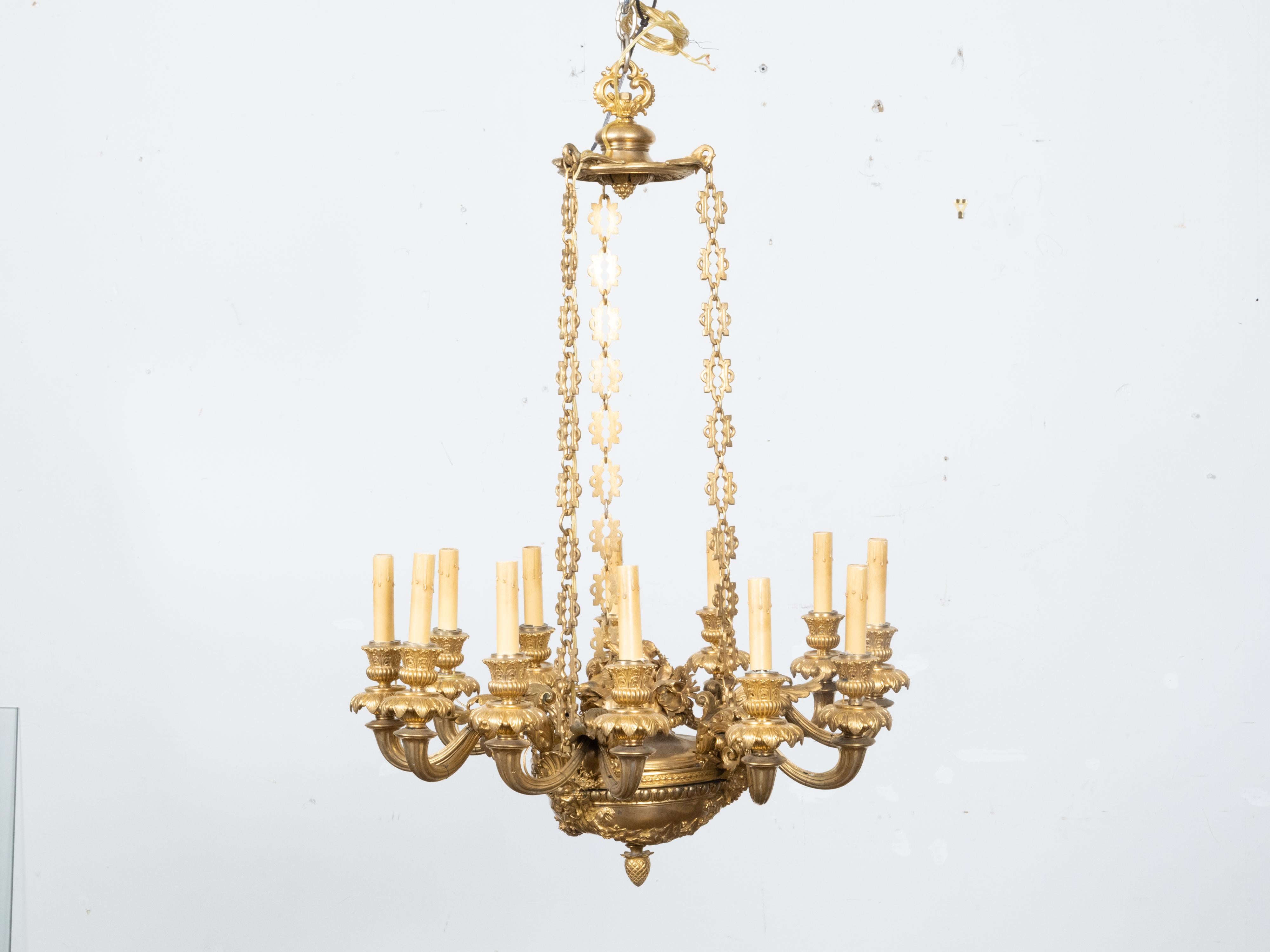 A French Napoléon III gilt bronze 12-light chandelier from the second half of the 19th century, with scrolling arms and abundant foliage motif. Embellish your space with the sublime grandeur of this French Napoléon III gilt bronze 12-light