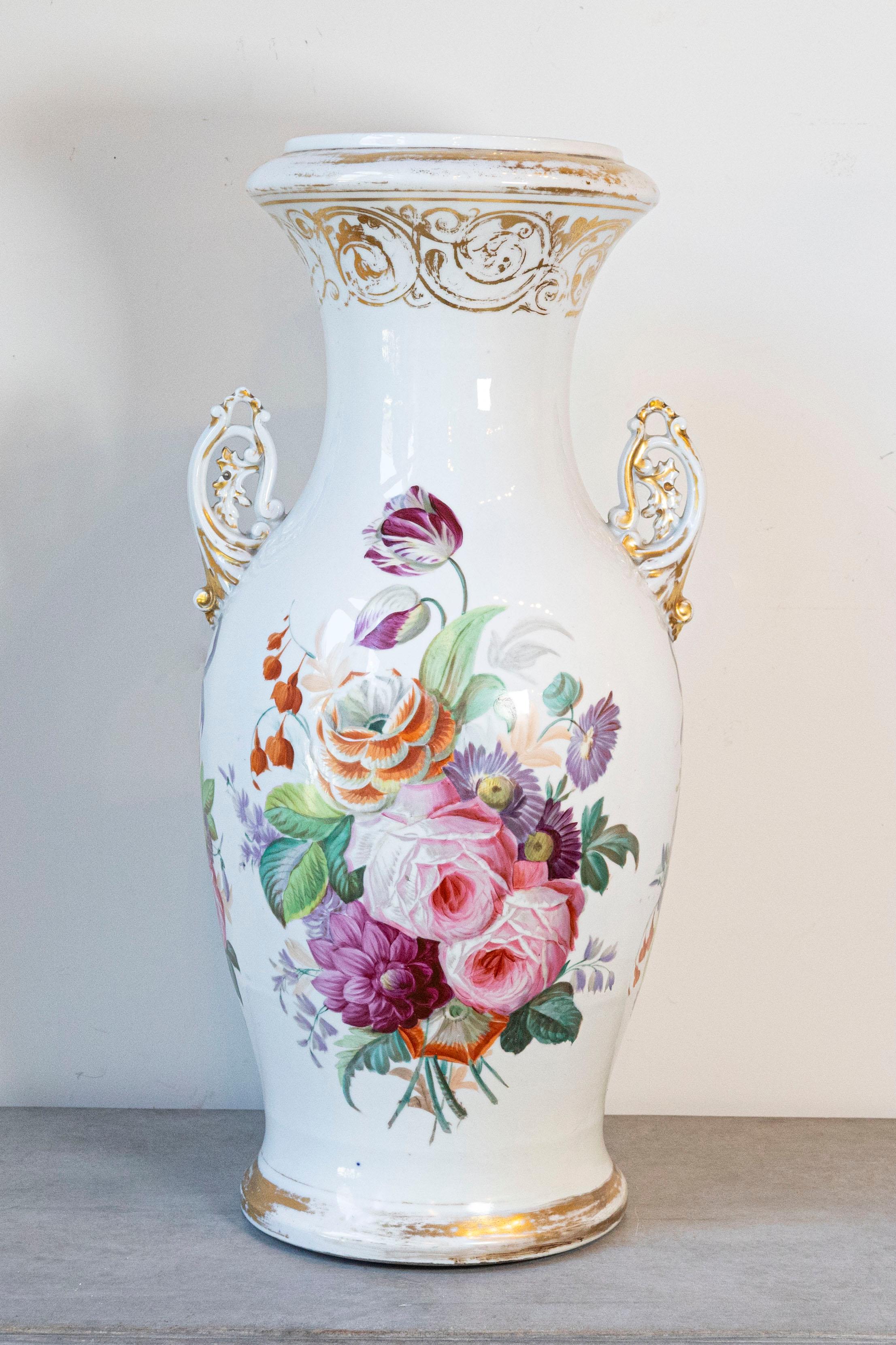 A French Napoleon III Paris porcelain vase from the second half of the 19th century with floral décor and parcel-gilt accents. Born in France during the ever changing 19th century, this porcelain vase features an exquisite décor of colorful flowers