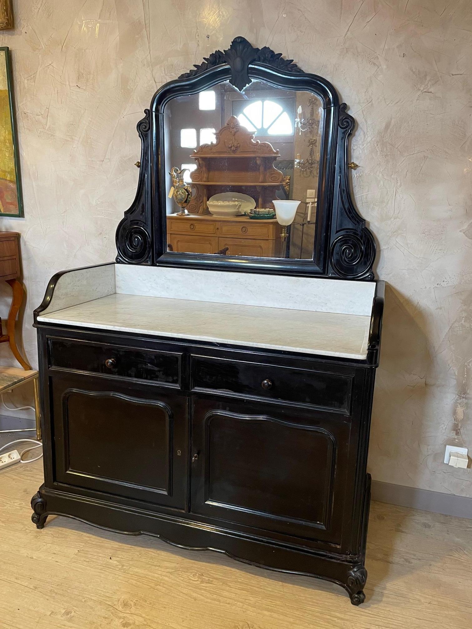 Beautiful Napoleon III blackened pearwood and marble dresser from the 1870s. 
Nice hand carved details of the doors and the top. 
Carrara Marble top. Two drawers and two large doors with a shelf inside. 
Large mirror. 
Some imperfections but