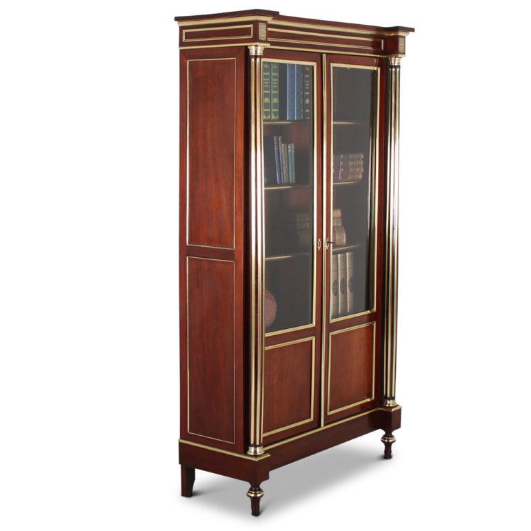 An elegant, two-door French Napoleon III bookcase, just restored in our workshop. The mahogany has been polished to a lovely color and the brass details contrast beautifully. All panels feature quarter-round brass edging and the columns have inlaid