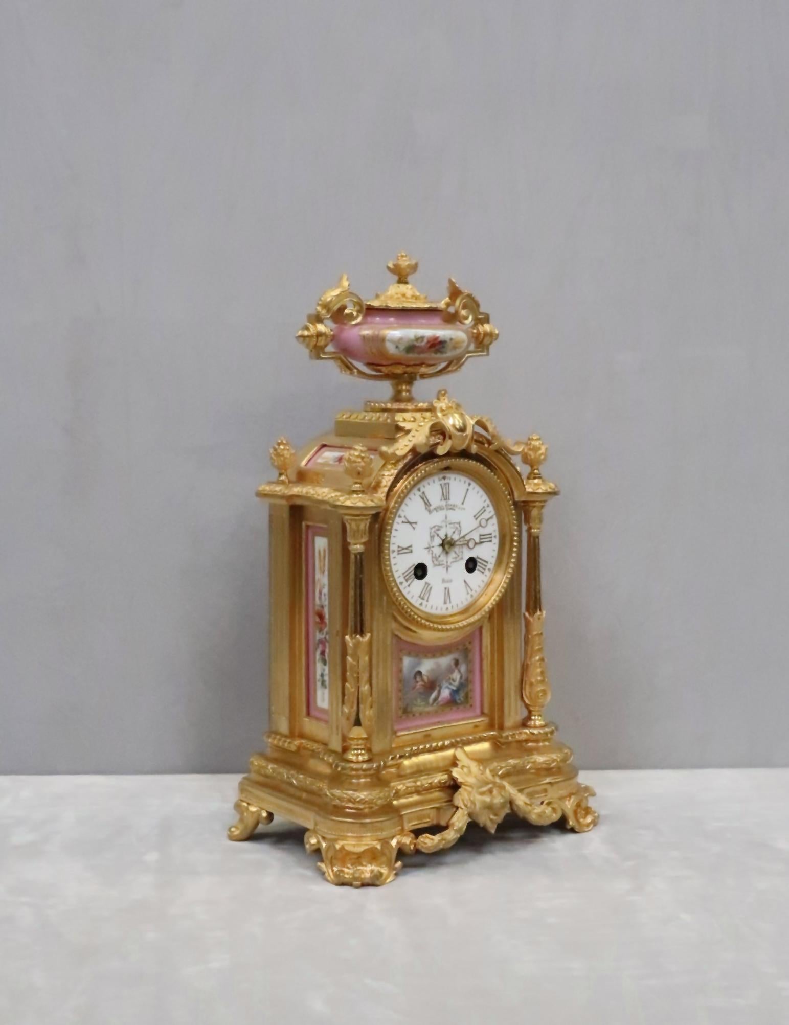 An extremely good quality French Napoleon III, Louis XIV style finely cast bronze gilt mantel clock with foliate design throughout, tapering reeded columns and masked mount stood on 'c' scroll feet finished with pineapple finials and decorative