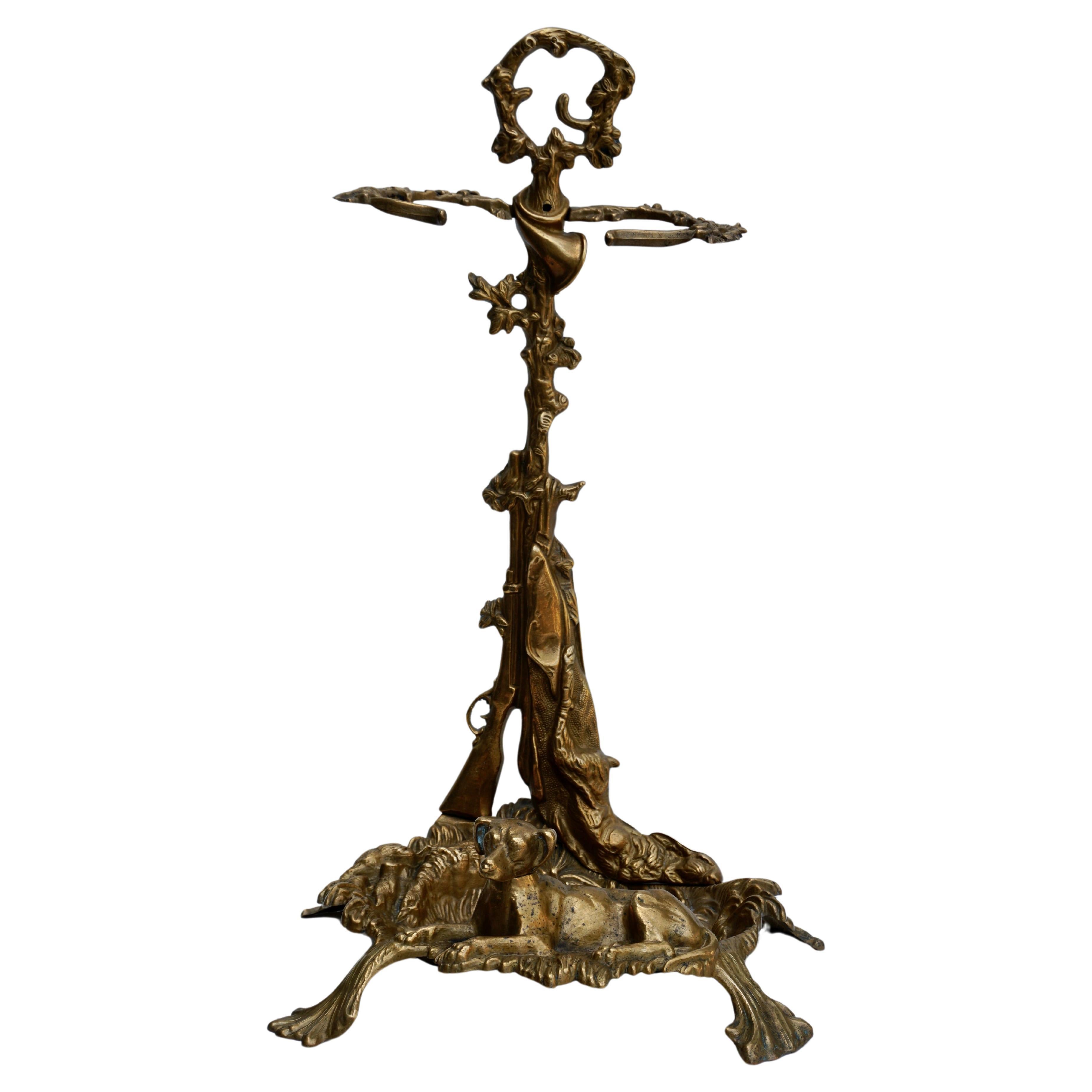 Decorate a hunting lodge with this fine antique umbrella or cane stand, crafted in France, circa 1900, the freestanding stand features a hunting theme including a horn at the top, a gun and a rabbit on the stem, and duck, partridge, foliage, and dog
