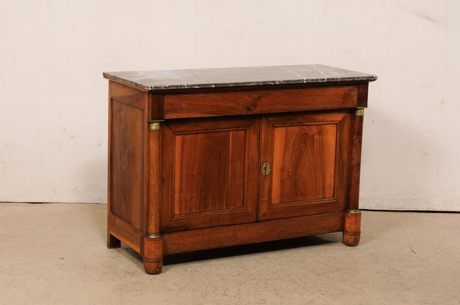 A French Napoleon III buffet, with its original marble top, from the early 19th century. This antique console from France, circa 1820's, features its original marble top over a case which houses a single drawer at top, over a pair of doors (with