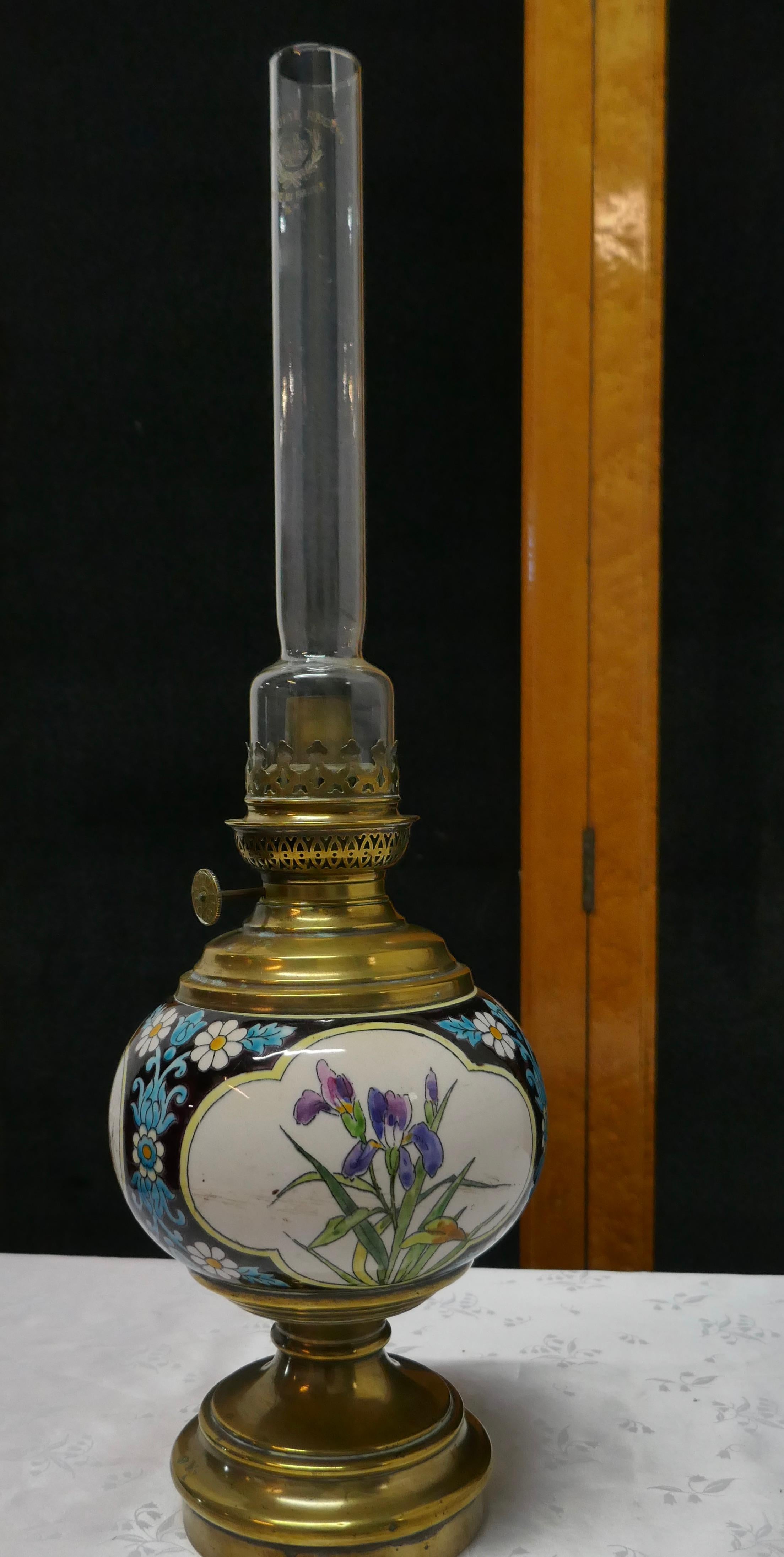 French Napoleon III ceramic oil lamp decorated with birds and flowers

A beautiful ceramic lamp set on a brass base, the lamp has colorful enamelled decoration in relief, it has wick, burner etc. but I cannot guarantee if these are in working