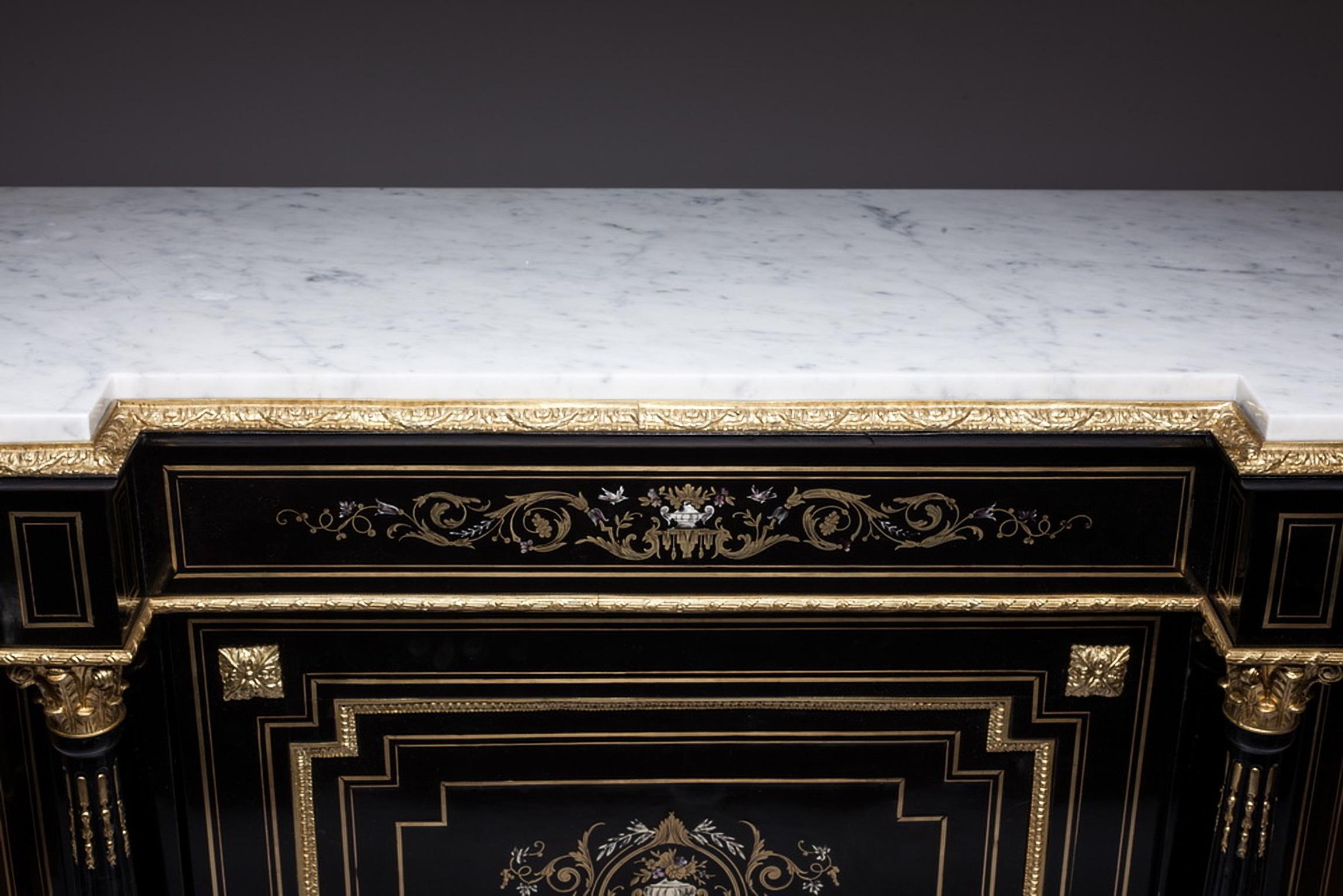 French Napoleon III ebonized and ormolu mounted, bronze and mother of pearl cabinet, circa 1860.
This beautiful cabinet is of Boulle marquetry of bronze and is inlaid with flower-filled urn, birds, ribbon-tied garlands made of pearls and bronze.